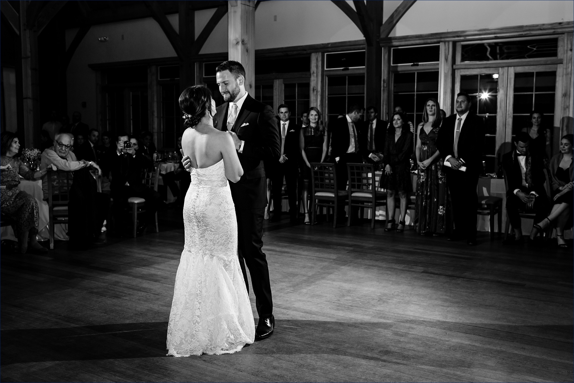The couple dances together at their Maine Wedding reception in a barn