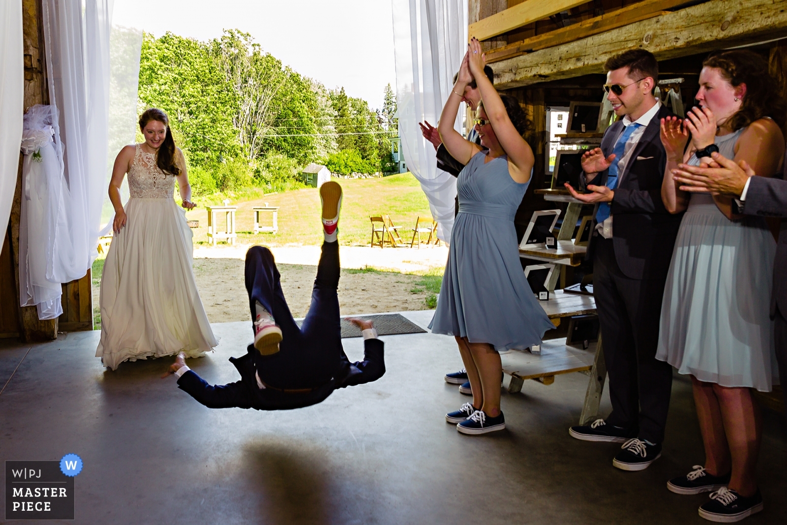 Kitz Farm Wedding Photographer captures award winning photo of the groom flipping into the reception