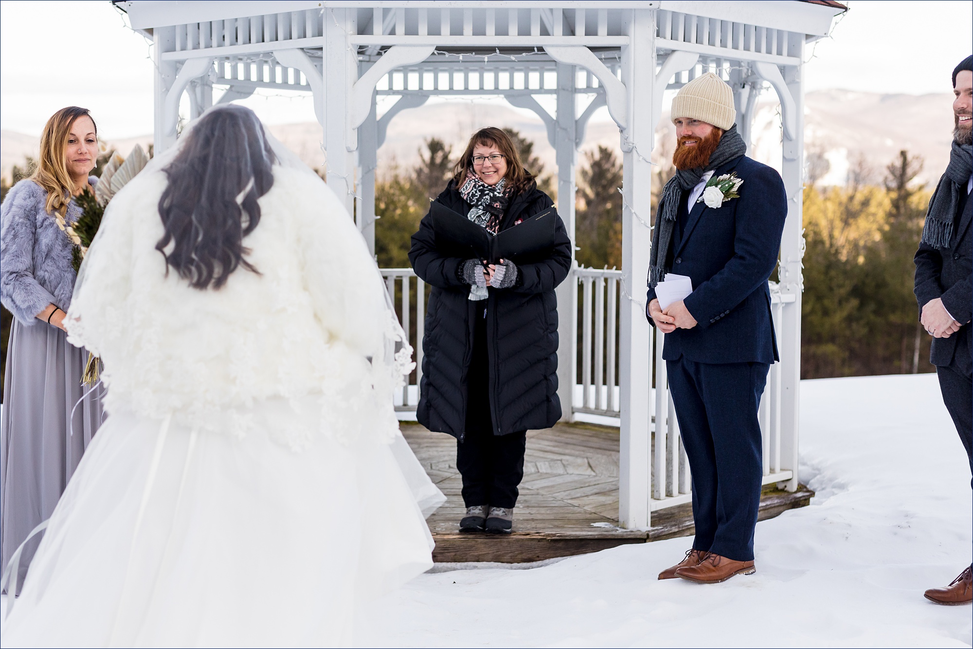 The bride heads to the groom for their winter ceremony outside in NH