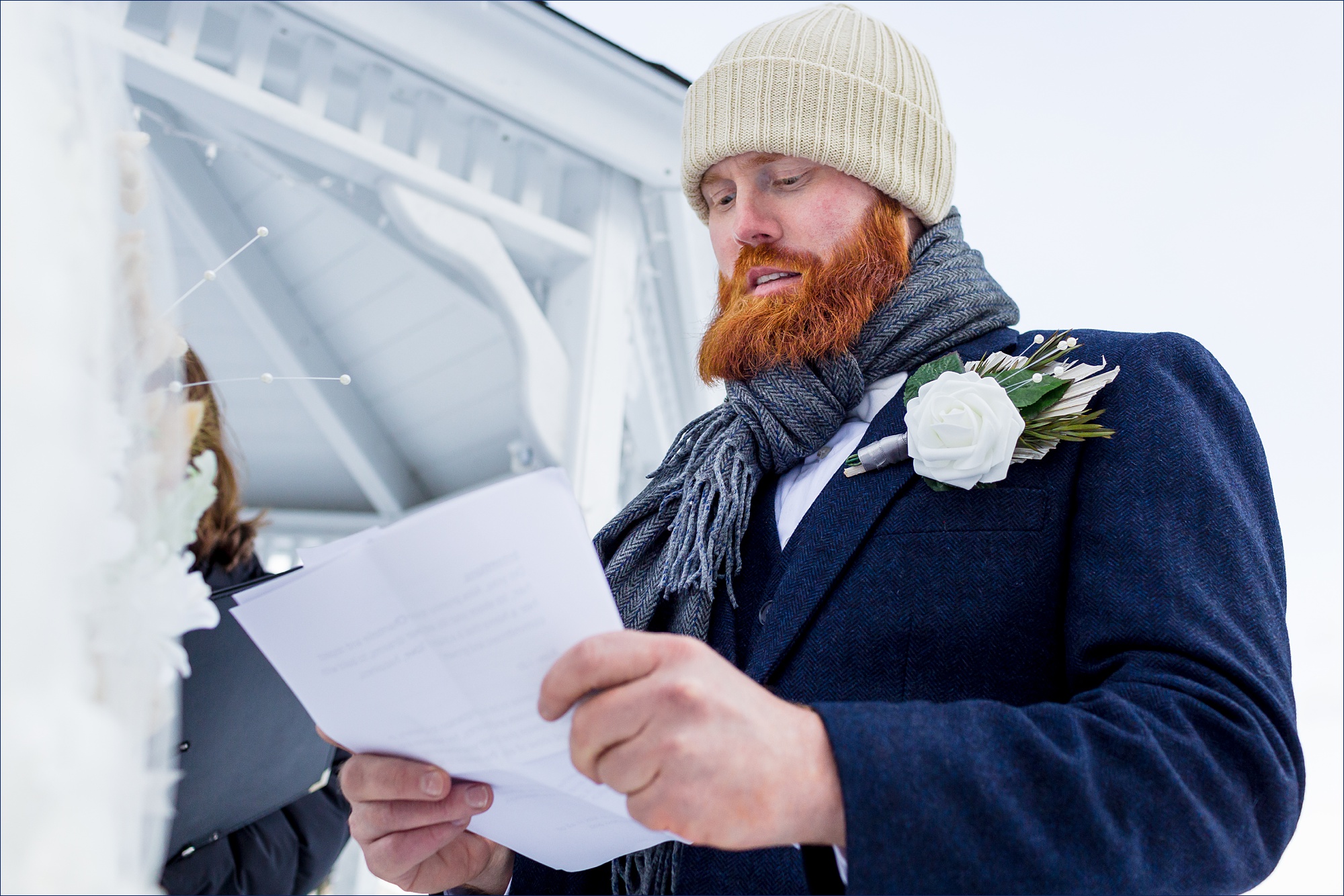 The groom reads his vows to the bride on their winter White Mountain NH elopement