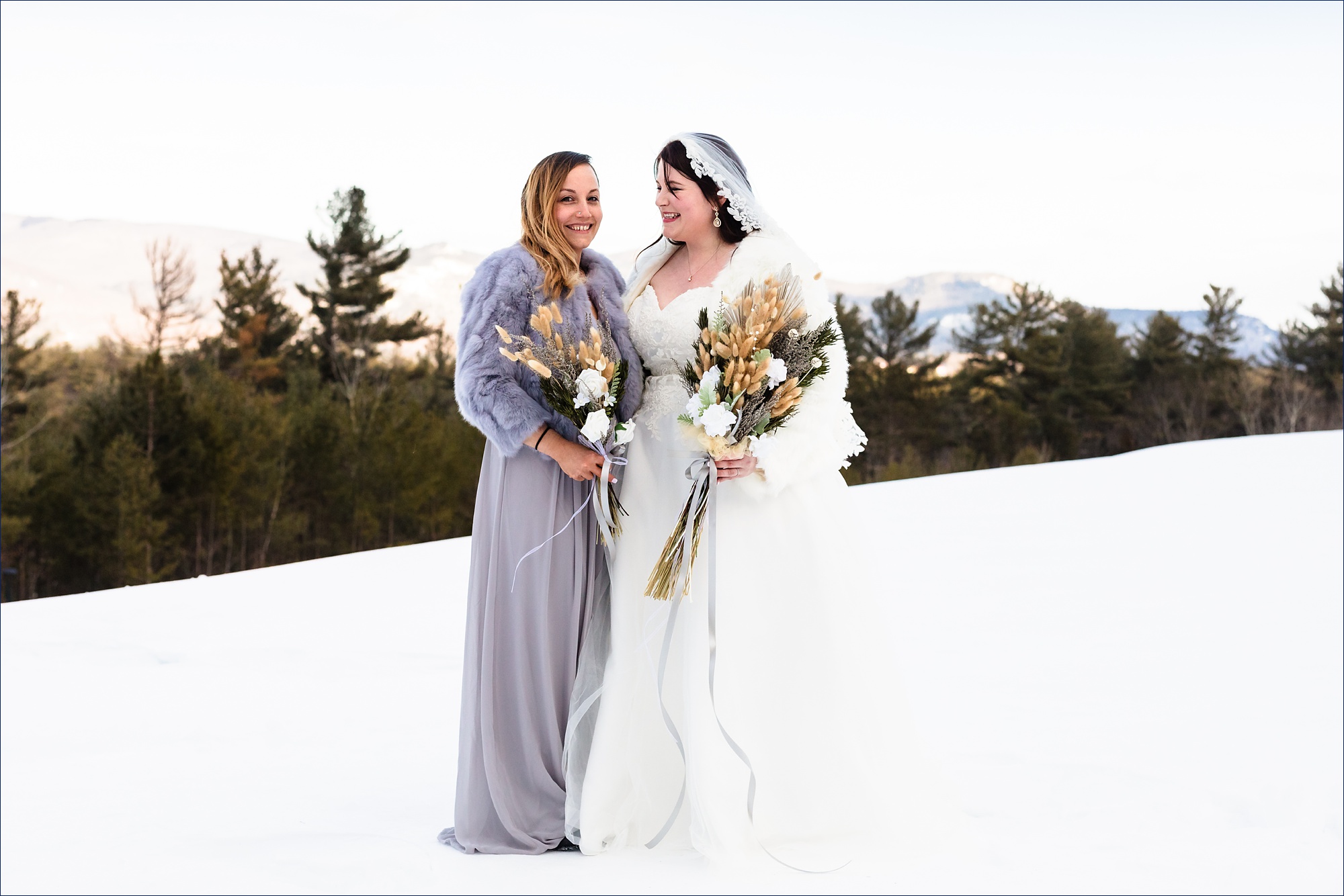 The bride smiles at her sister on her NH elopement day in the White Mountains