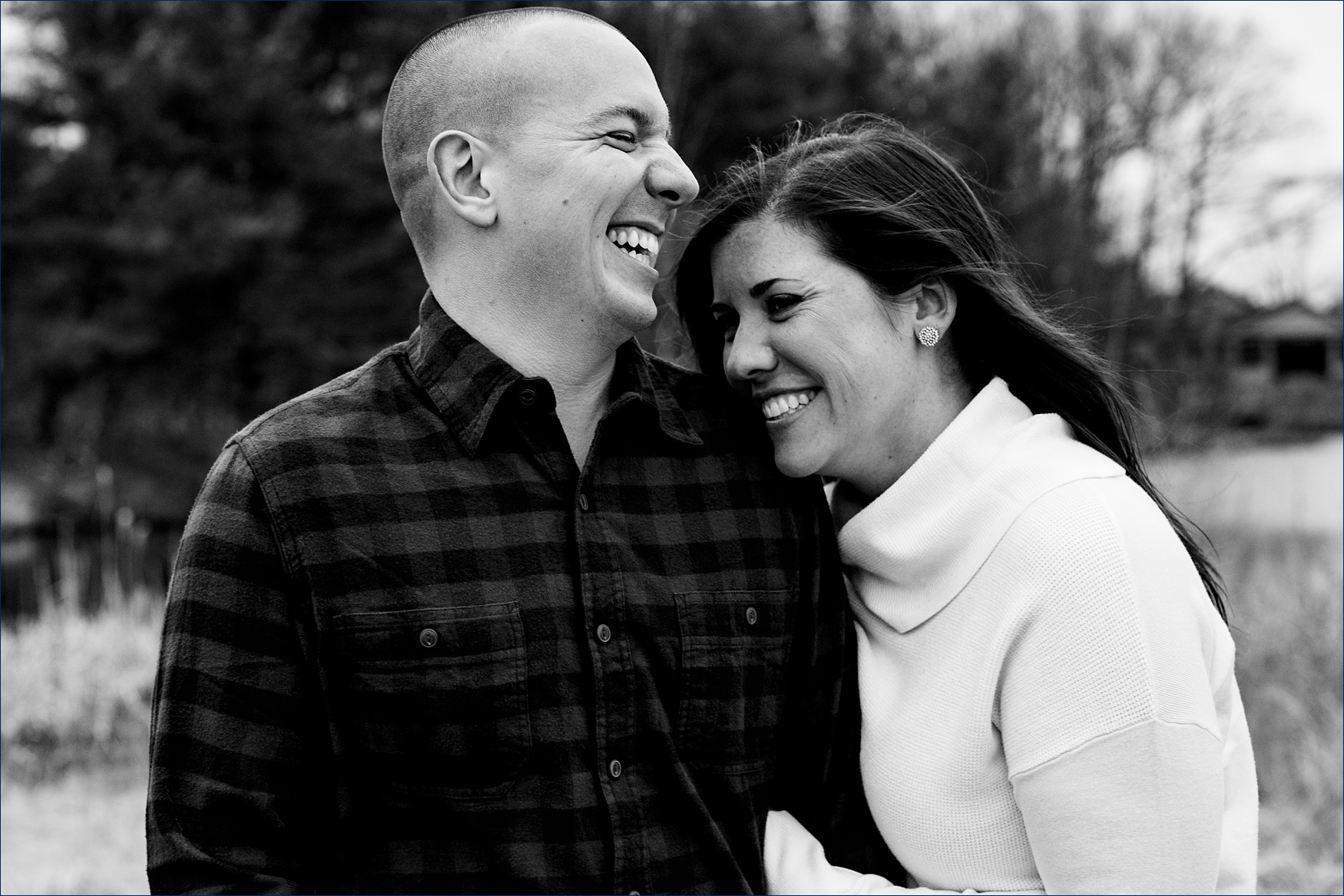 The engaged couple share a laugh together at their Portsmouth NH engagement session on a Spring day