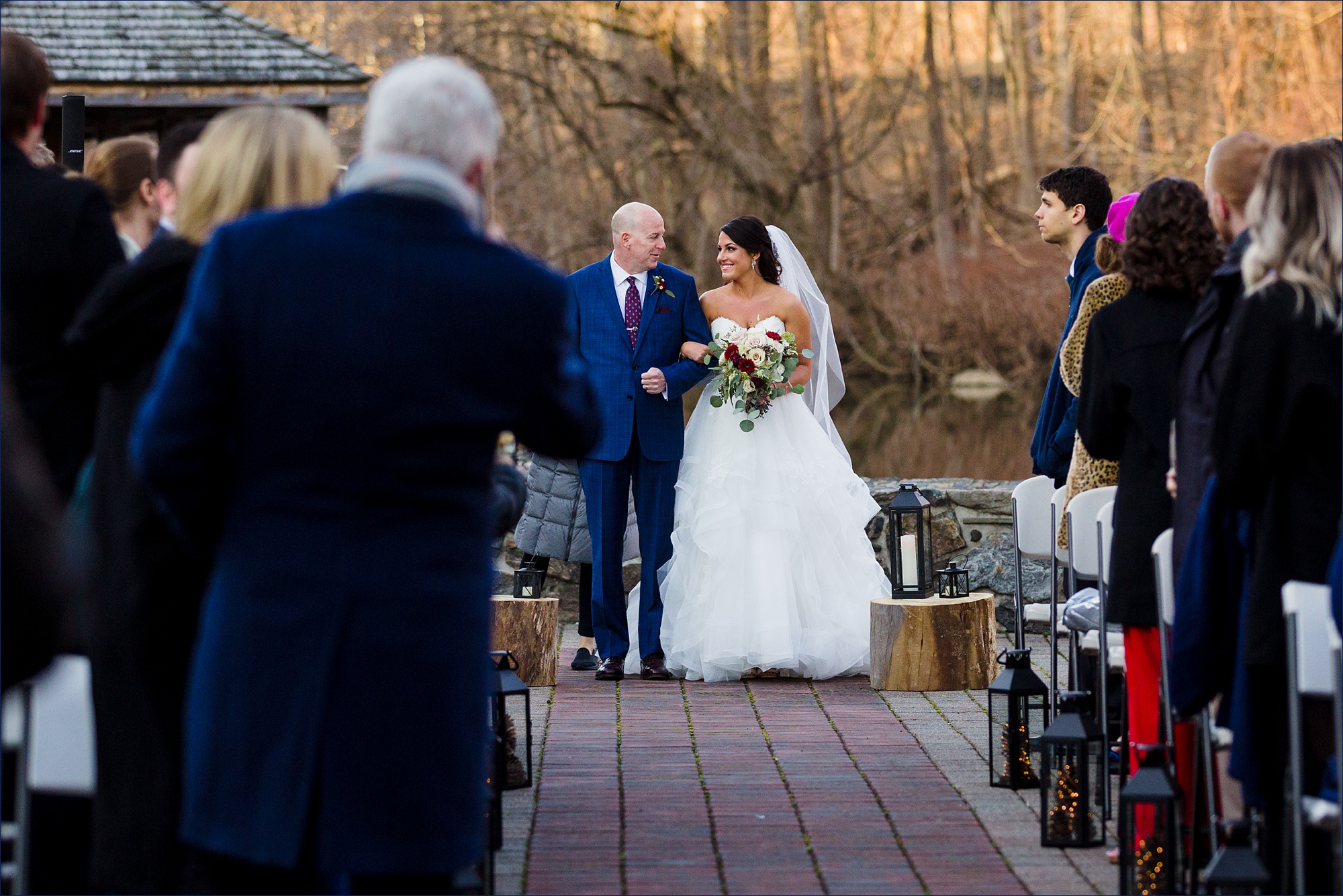The bride and her father walk down the aisle together