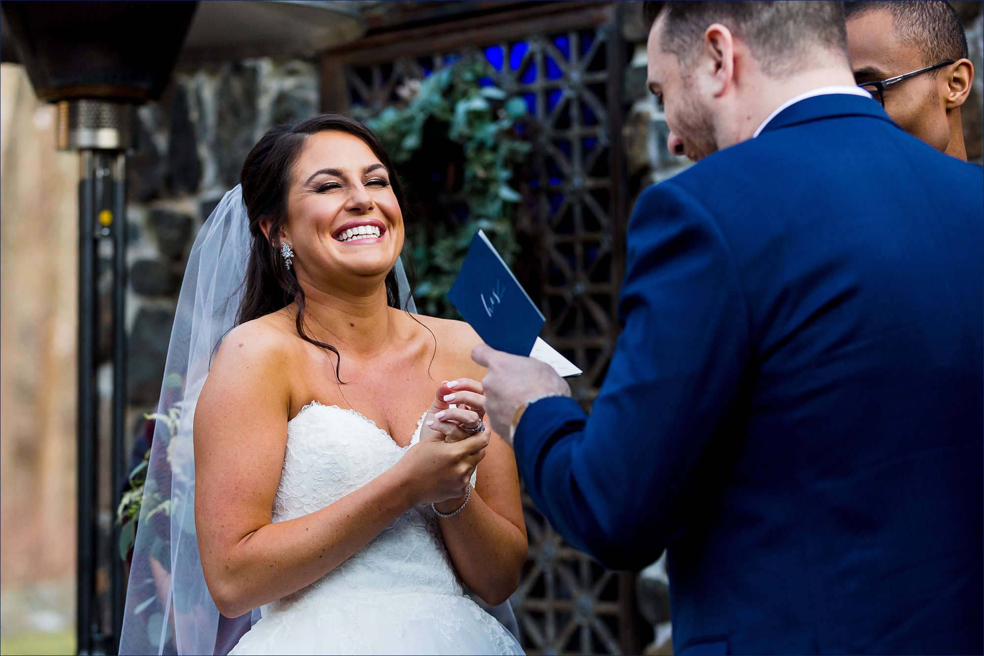 Bride laughs during the groom's vows to her 