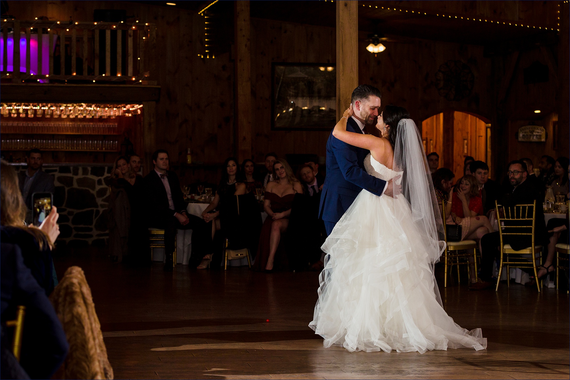 The bride and groom do their first dance at the wedding reception