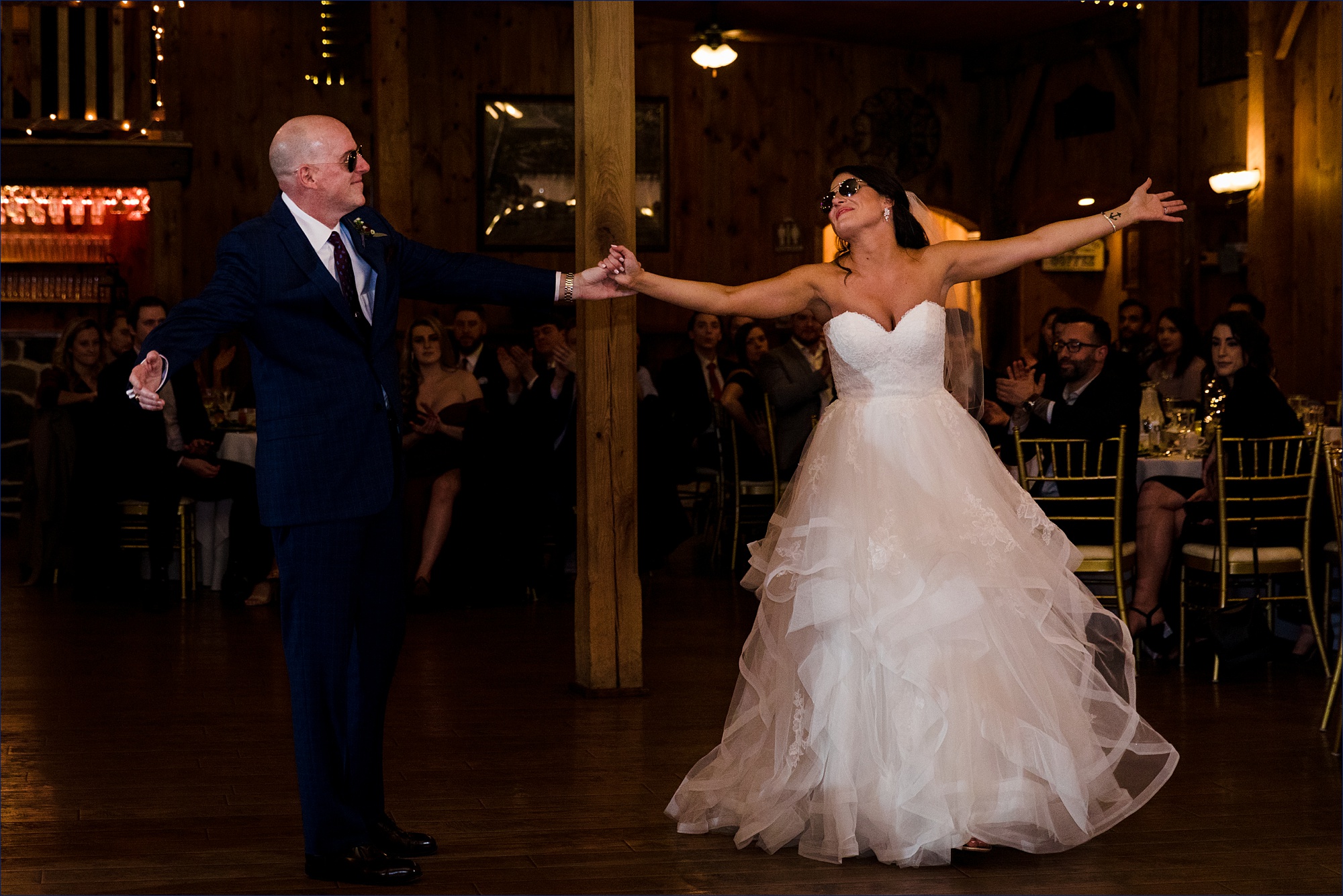 The bride and her father dance together at the wedding reception
