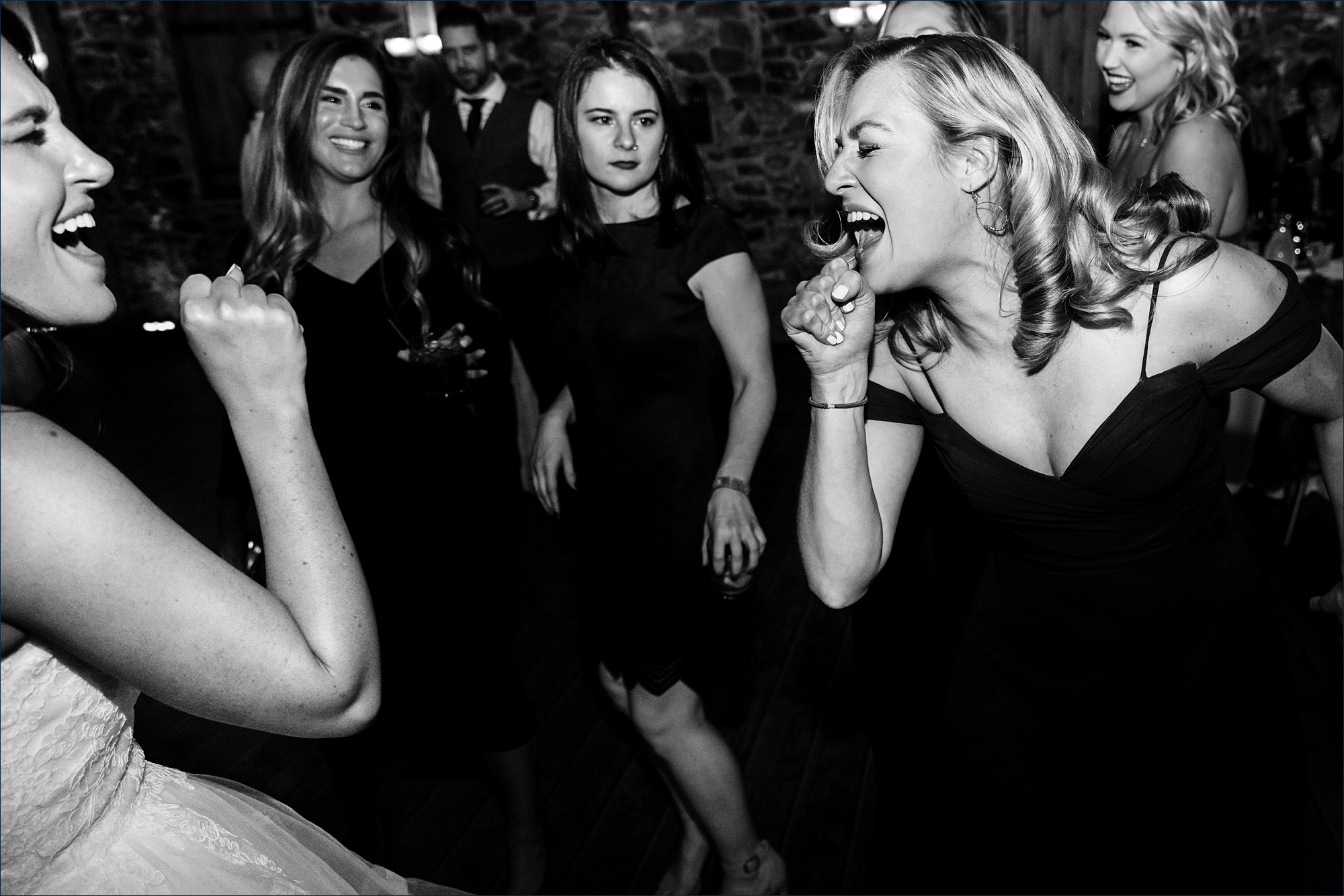A sing off from the bride and her bridesmaid on the dance floor
