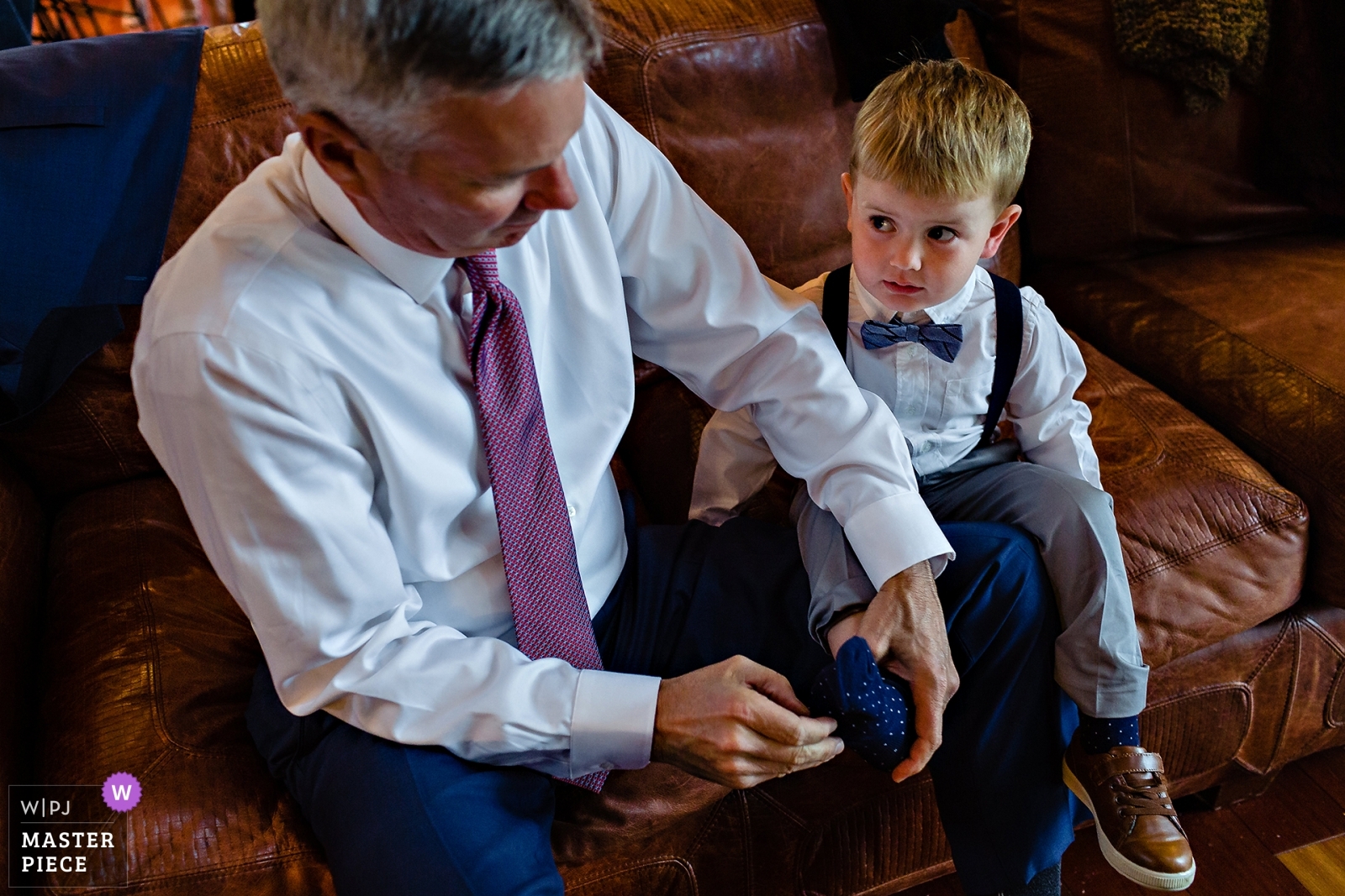 Maine Wedding Photographer wins award for grandpa putting on his grandson's shoes