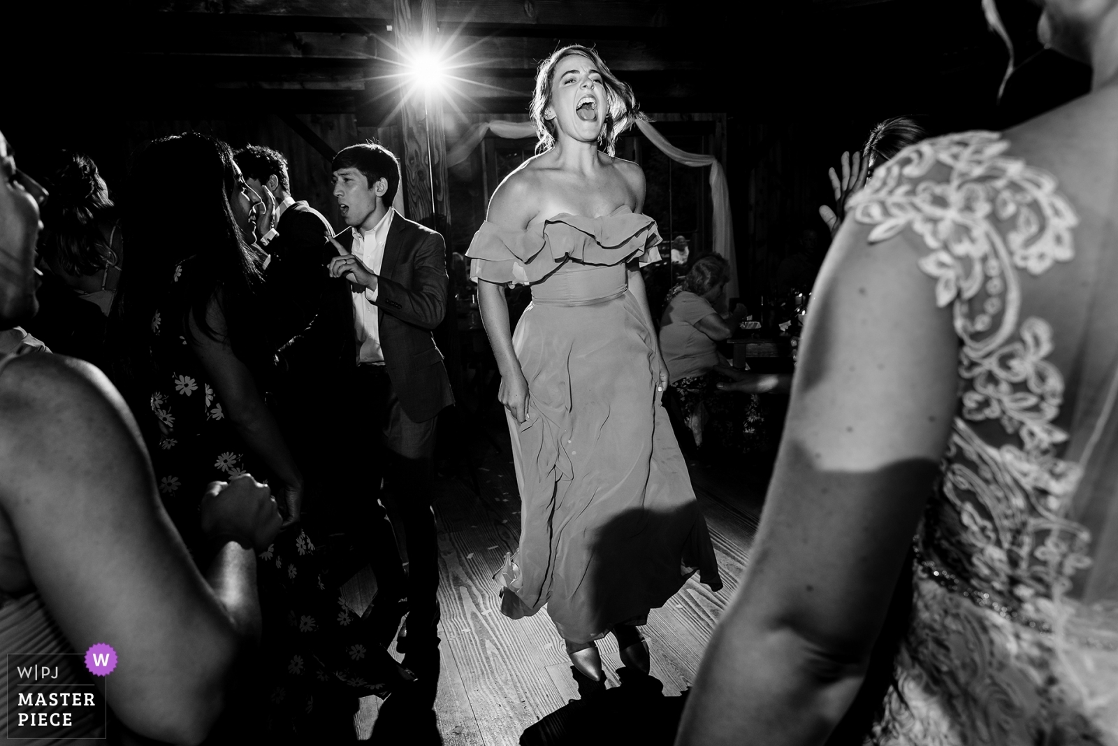 Bridesmaid gets into the music and the party at The Preserve at Chocorua wedding day in New Hampshire