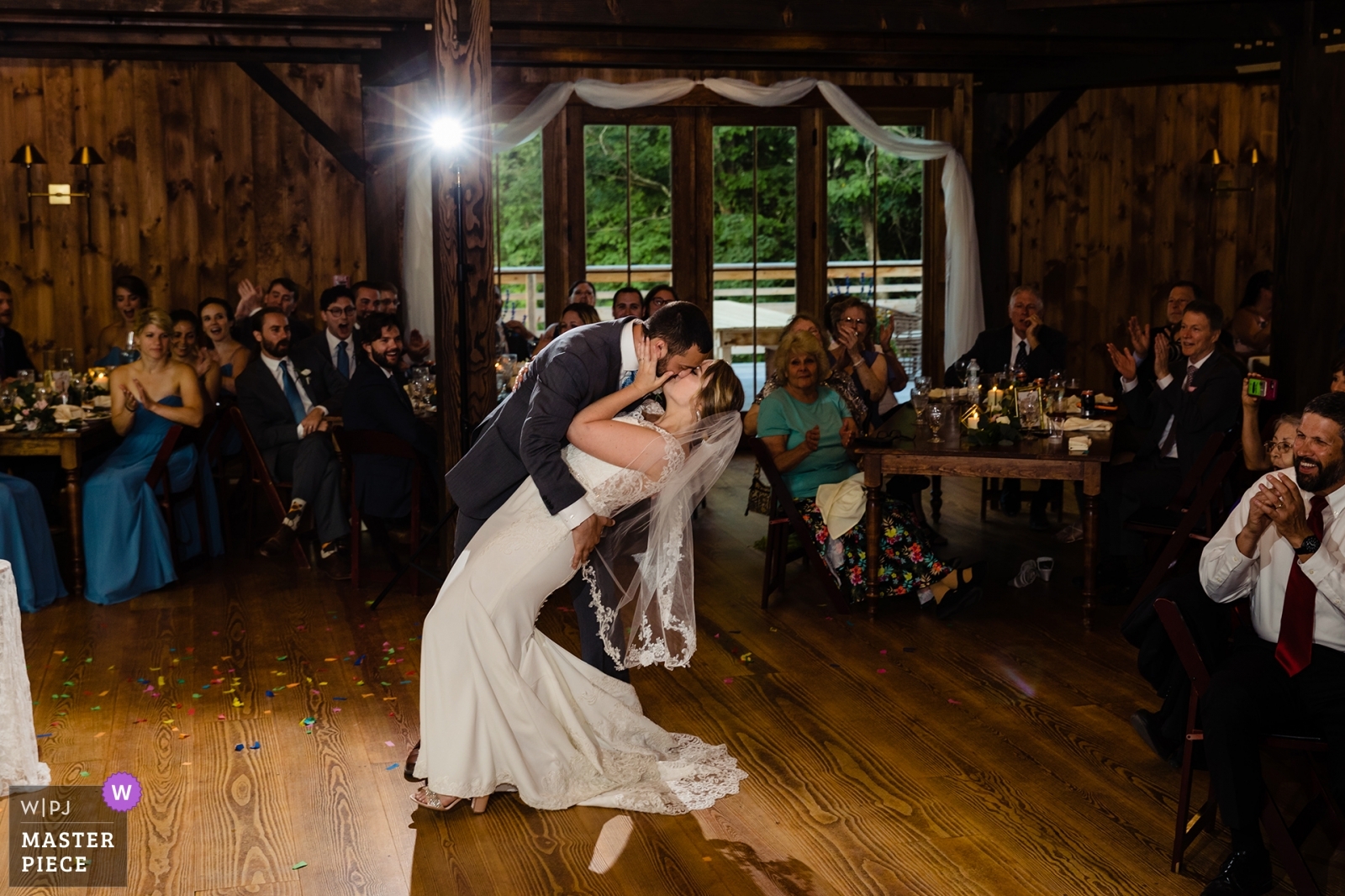 Groom dips the bride at their barn reception at The Preserve at Chocorua wedding day
