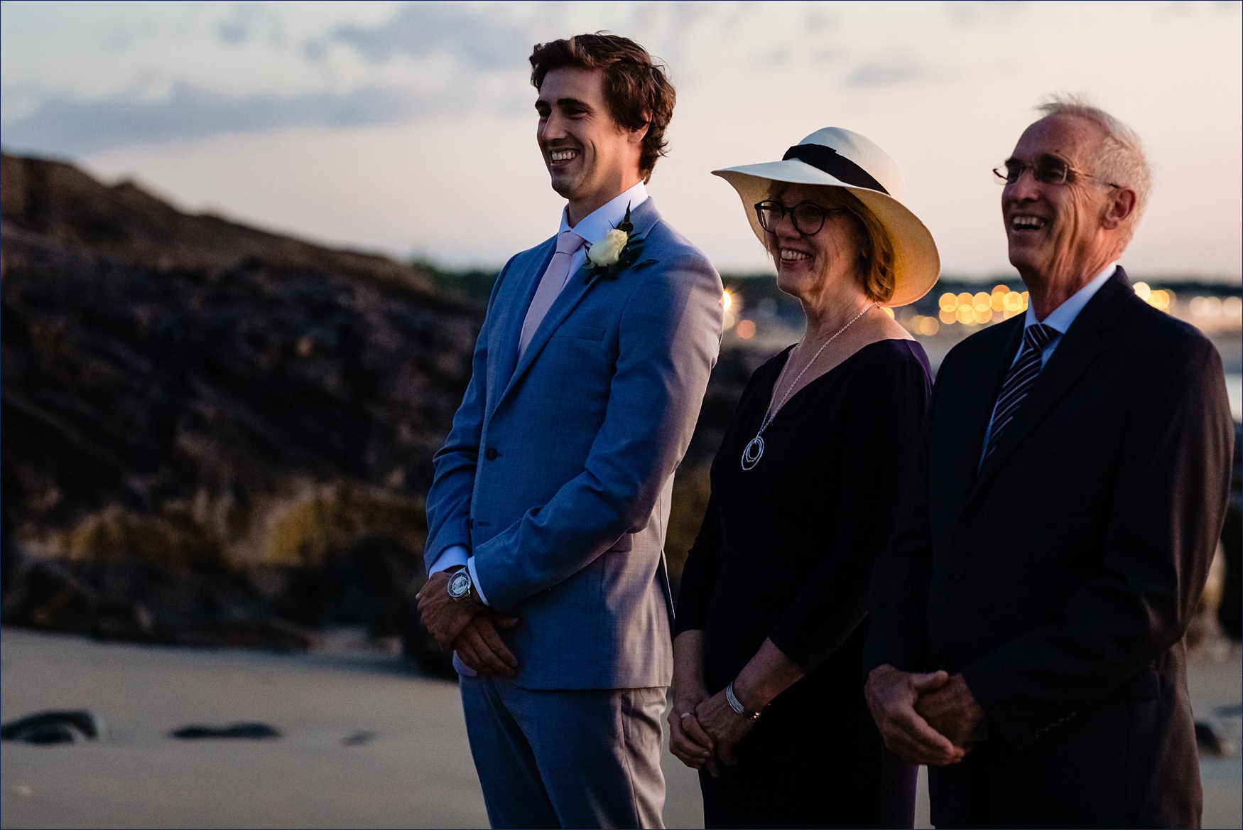 The groom watches as the bride makes her way to the ceremony at sunrise on the Ogunquit Maine beach