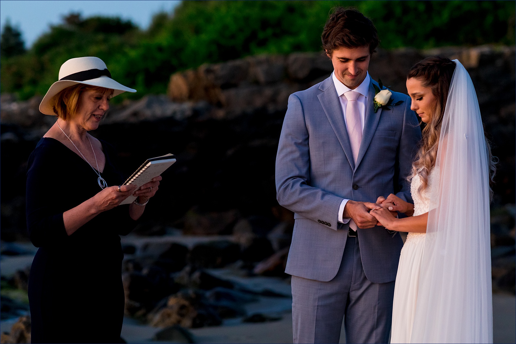 As the sun comes up, the couple listens to readings during their ceremony in Ogunquit Maine