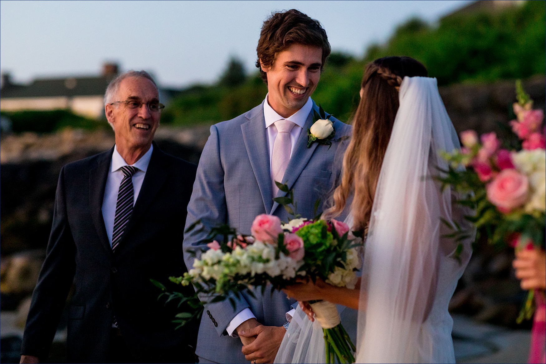 The groom smiles warmly at his new wife after their sunrise ceremony