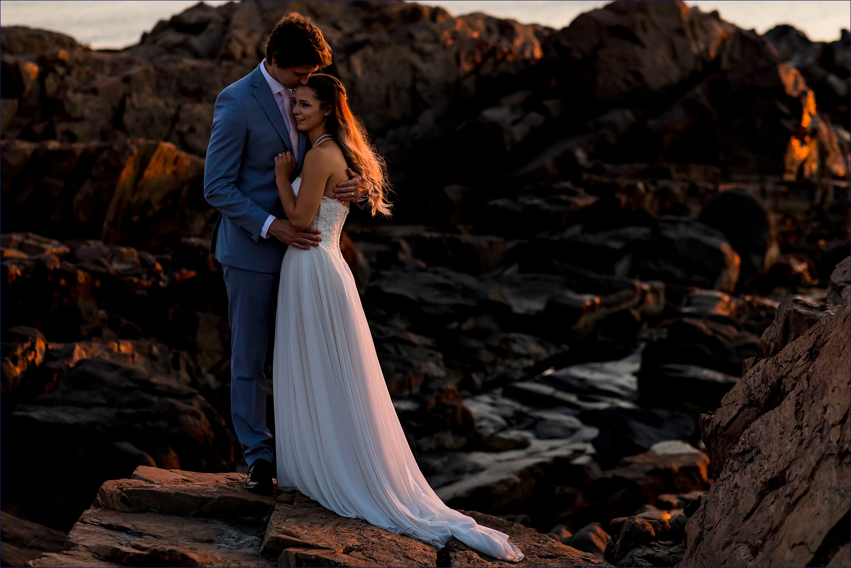The bride and groom stand out on the Marginal Way rocks for the Maine elopement at sunrise
