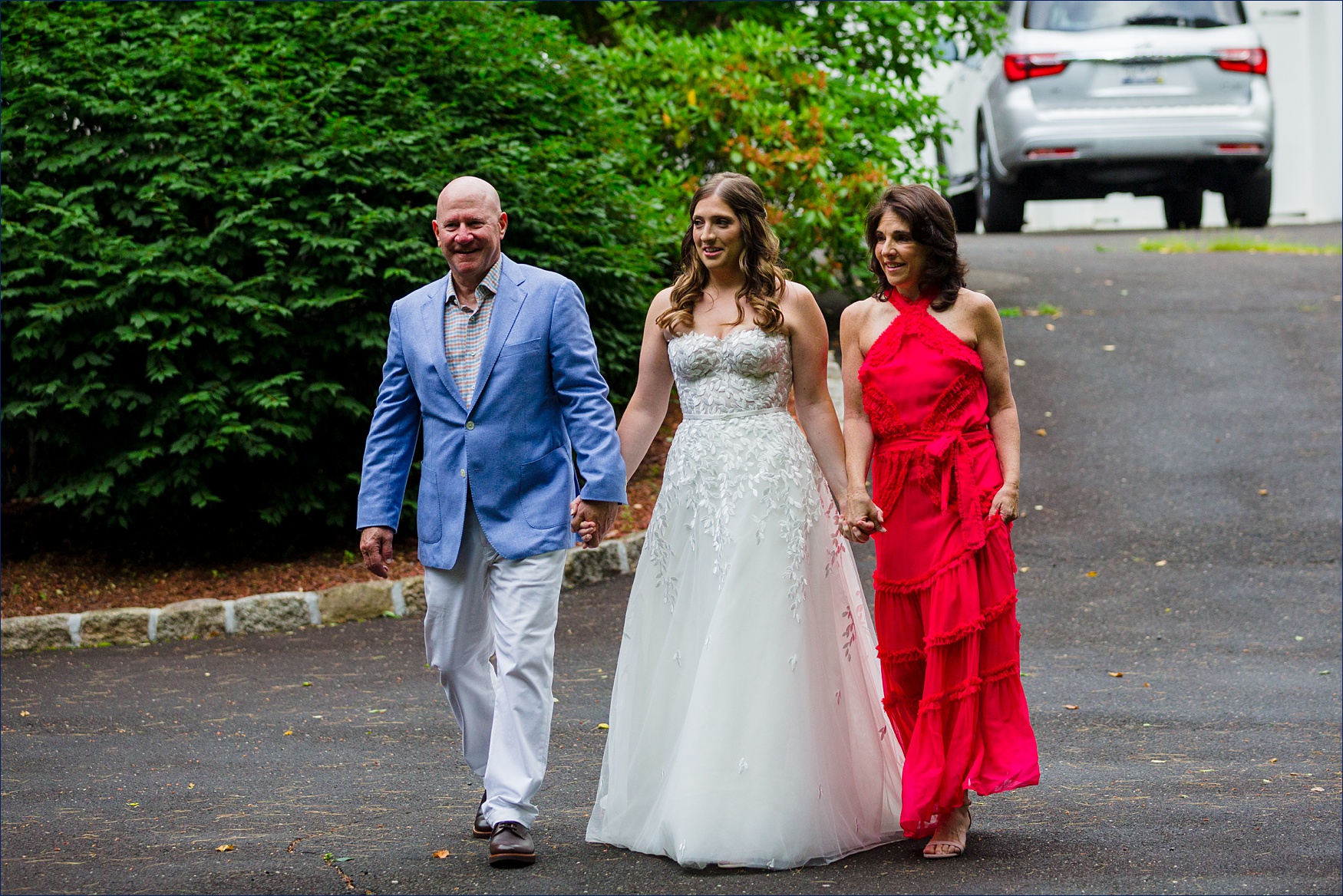 The bride and her parents enter the backyard intimate ceremony