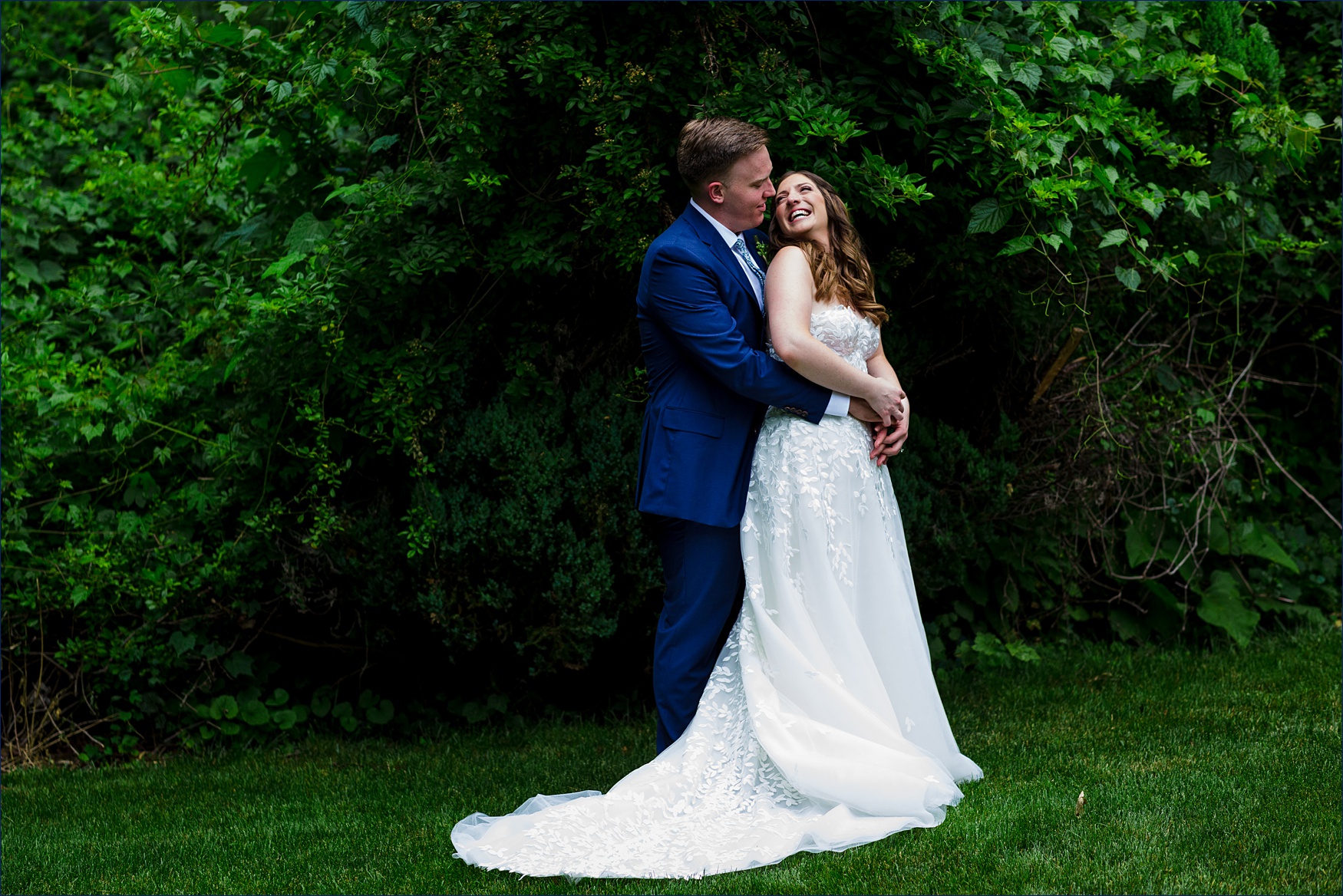 A laugh and a snuggle for the bride and groom after their backyard intimate wedding