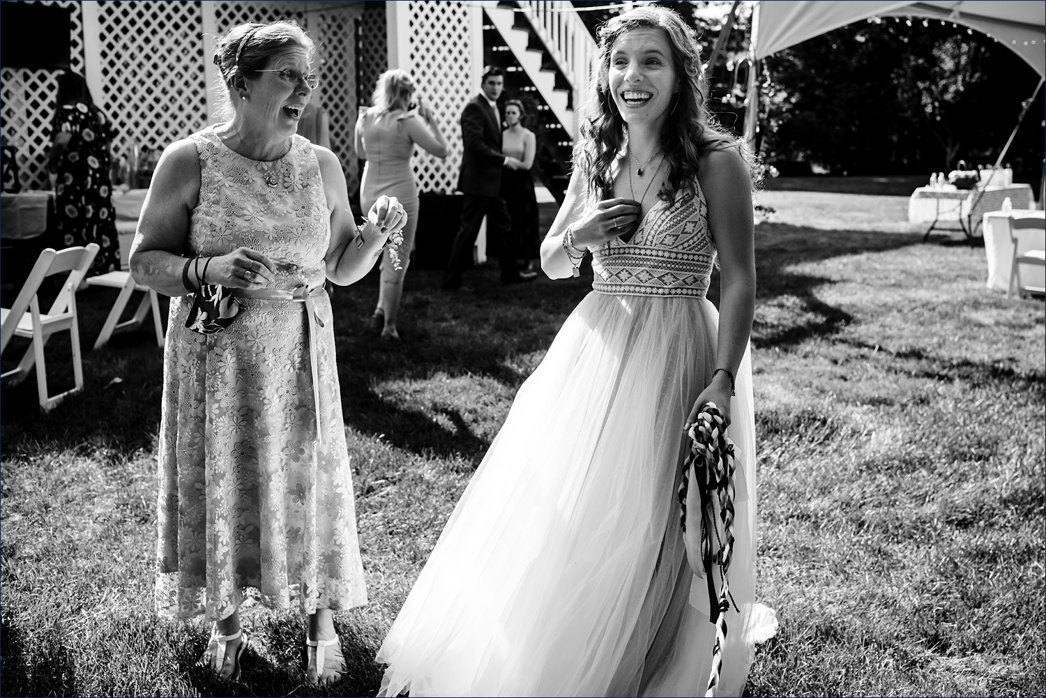 The bride and her mom celebrate the backyard wedding ceremony being complete
