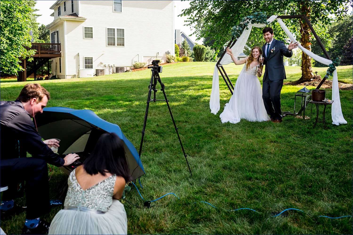 The newlyweds sign off of the Zoom call with family and friends after their backyard intimate wedding in Andover MA