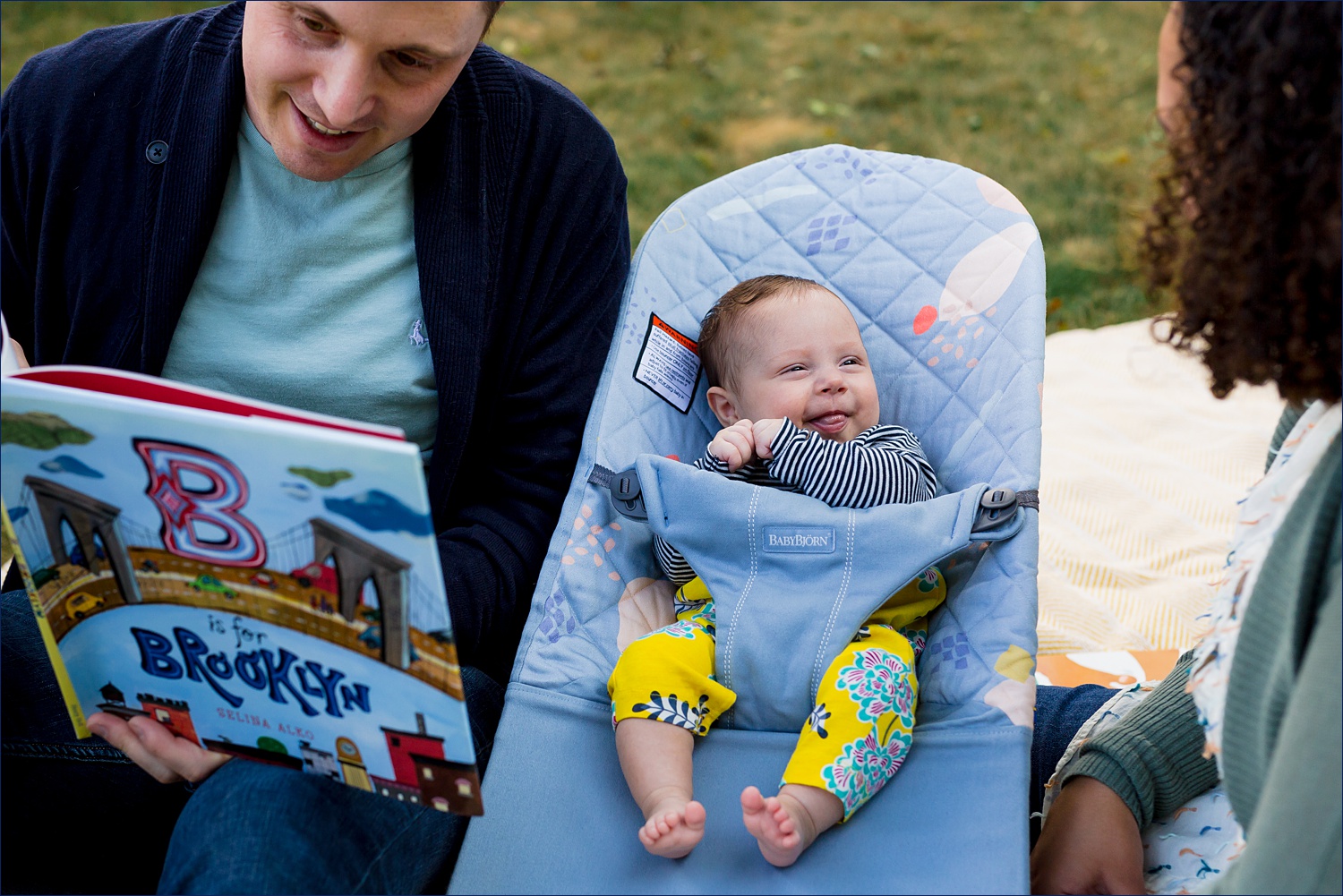 Baby is read to by her parents