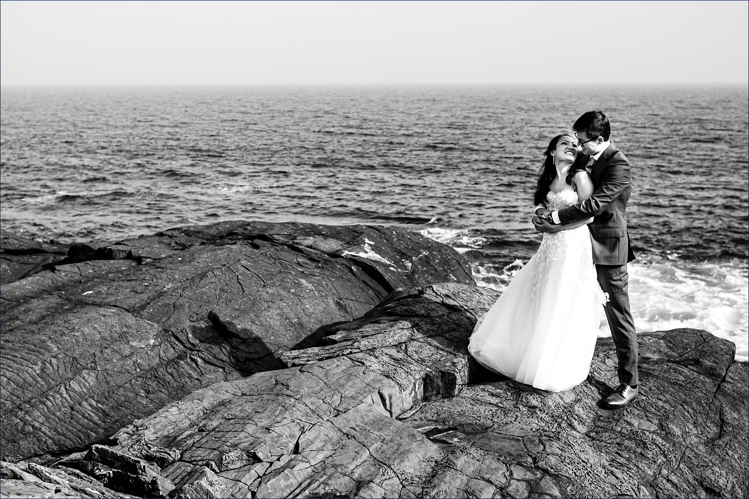 A hug and a kiss while out on the rocks at Cliff House Maine