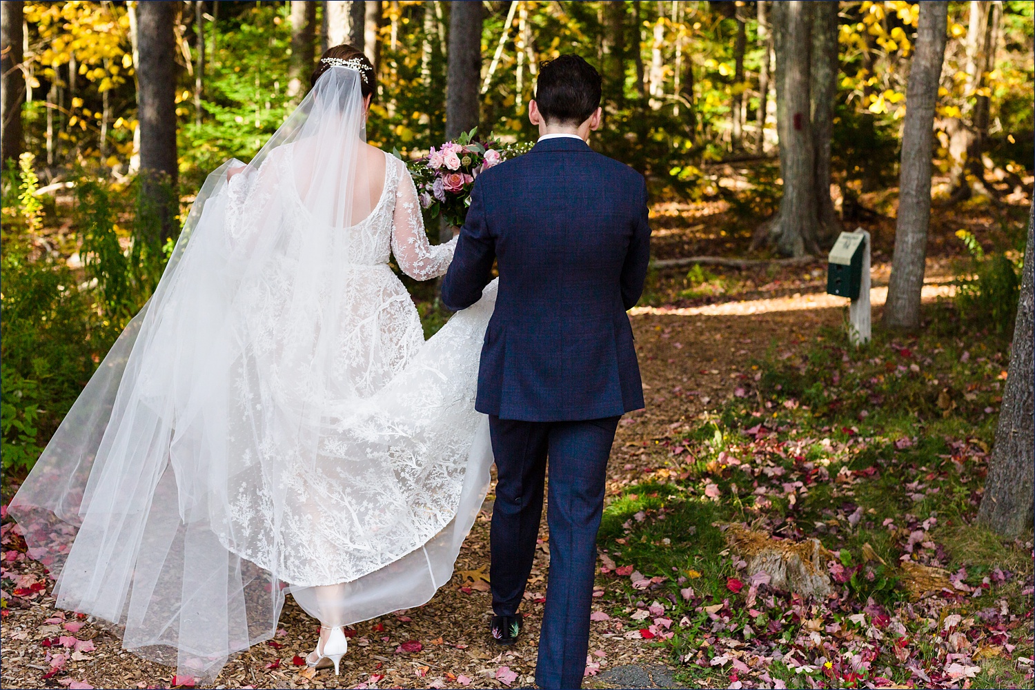 The bride heads to the first look with help from her brother in the woods