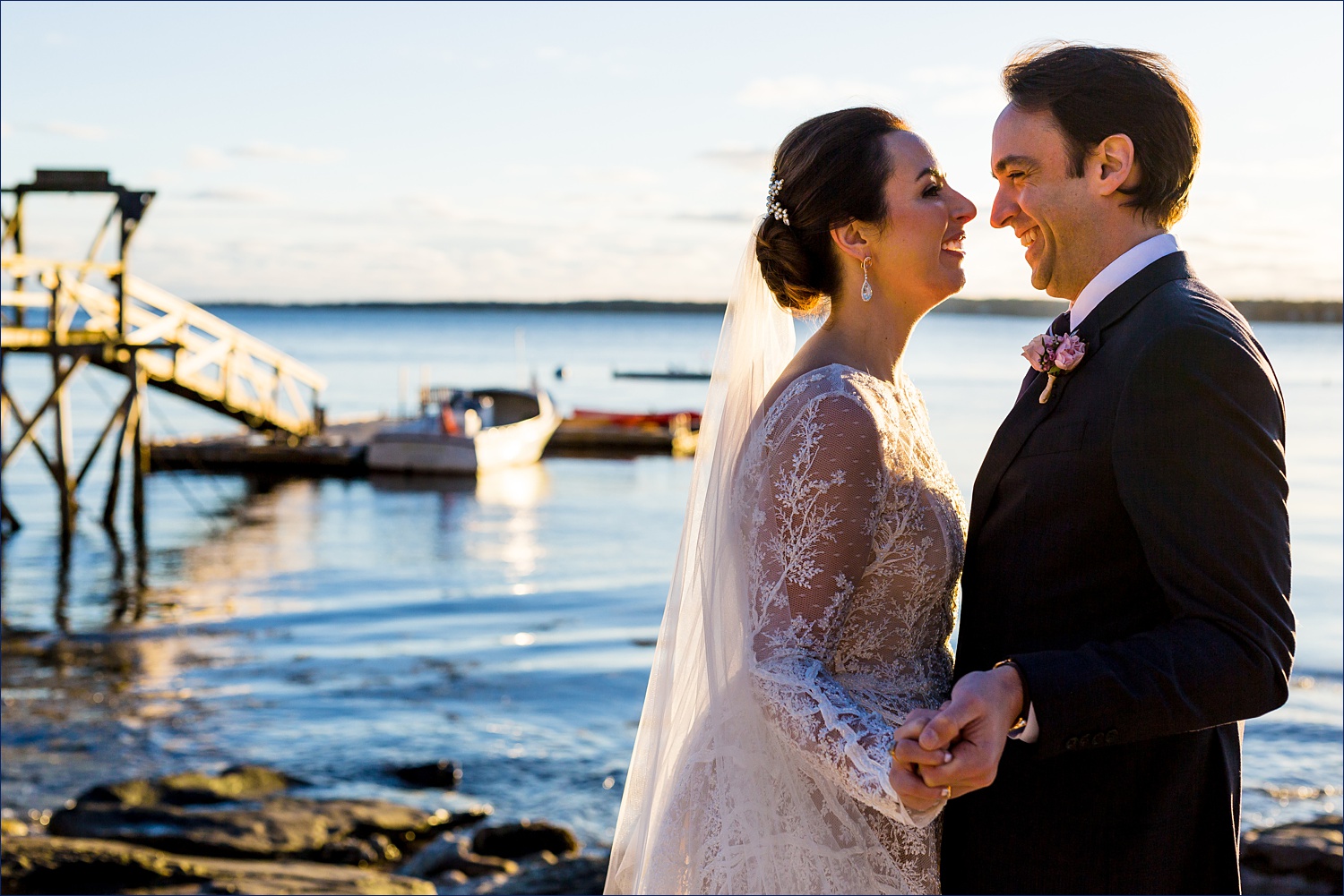 The bride and groom enjoy a laugh out by the water in Midcoast Maine