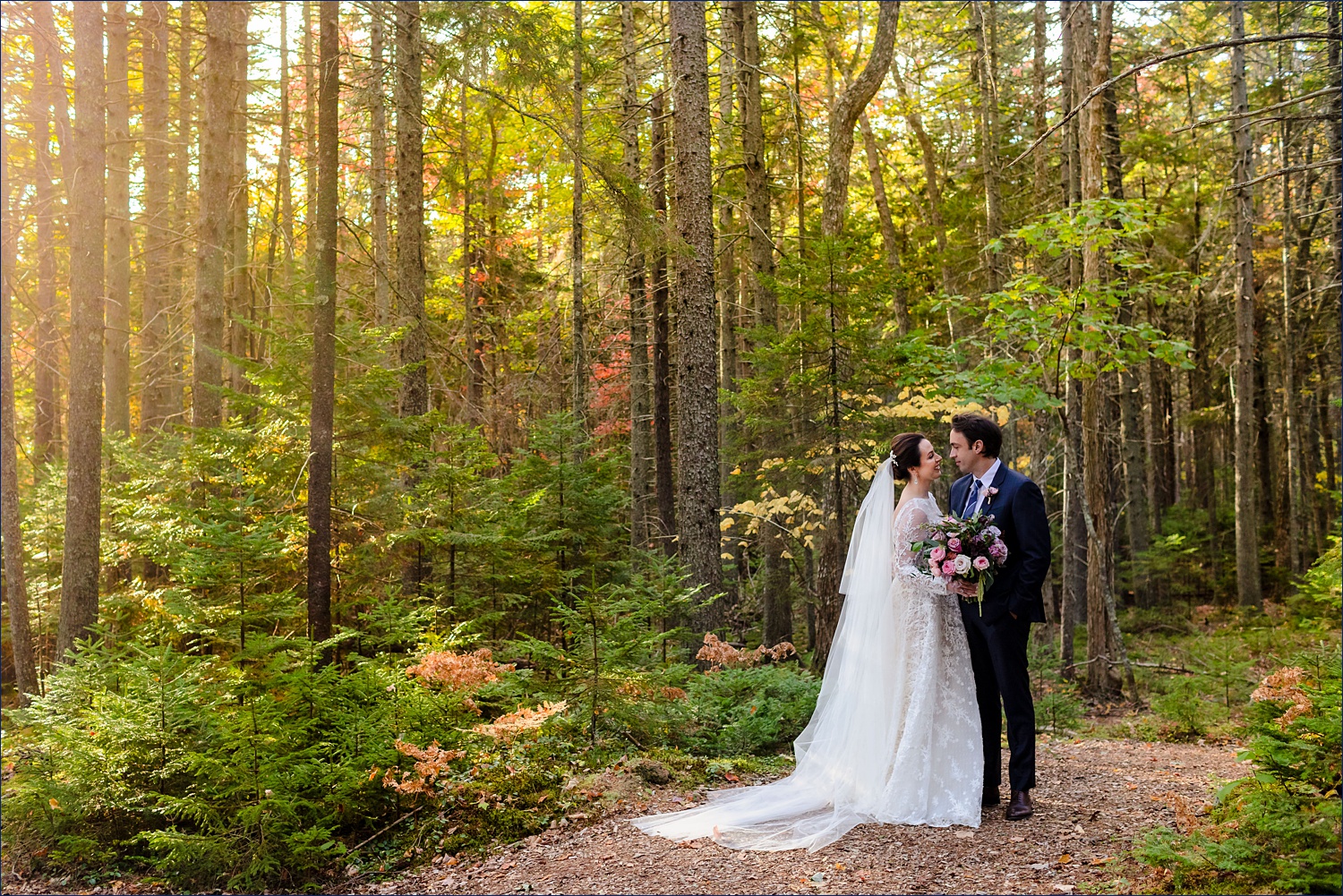 The bride and groom hang out in the woods of Spruce Point Inn in the woods of Boothbay Harbor Maine