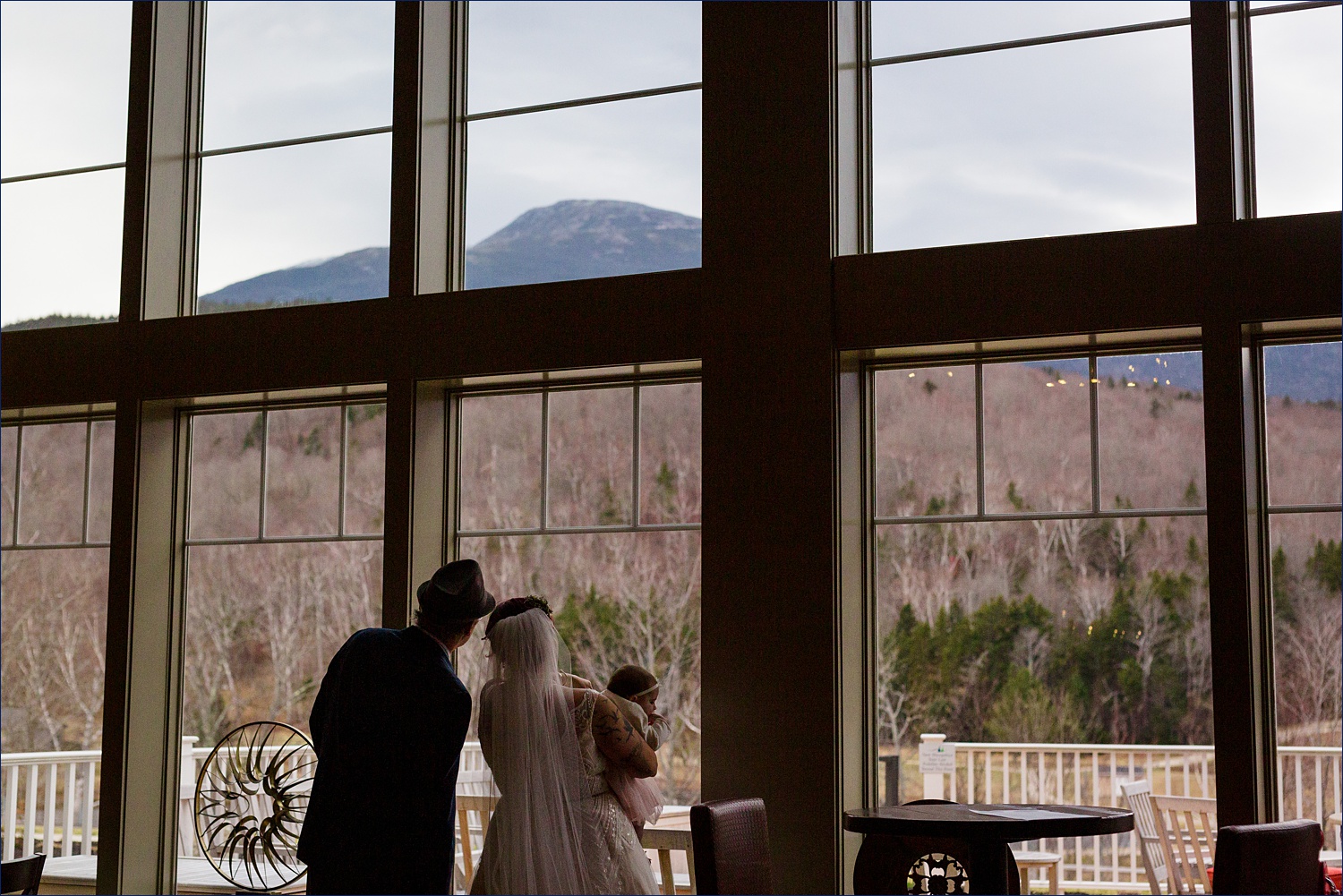 The bride and her father look up at Mount Washington on her elopement day 