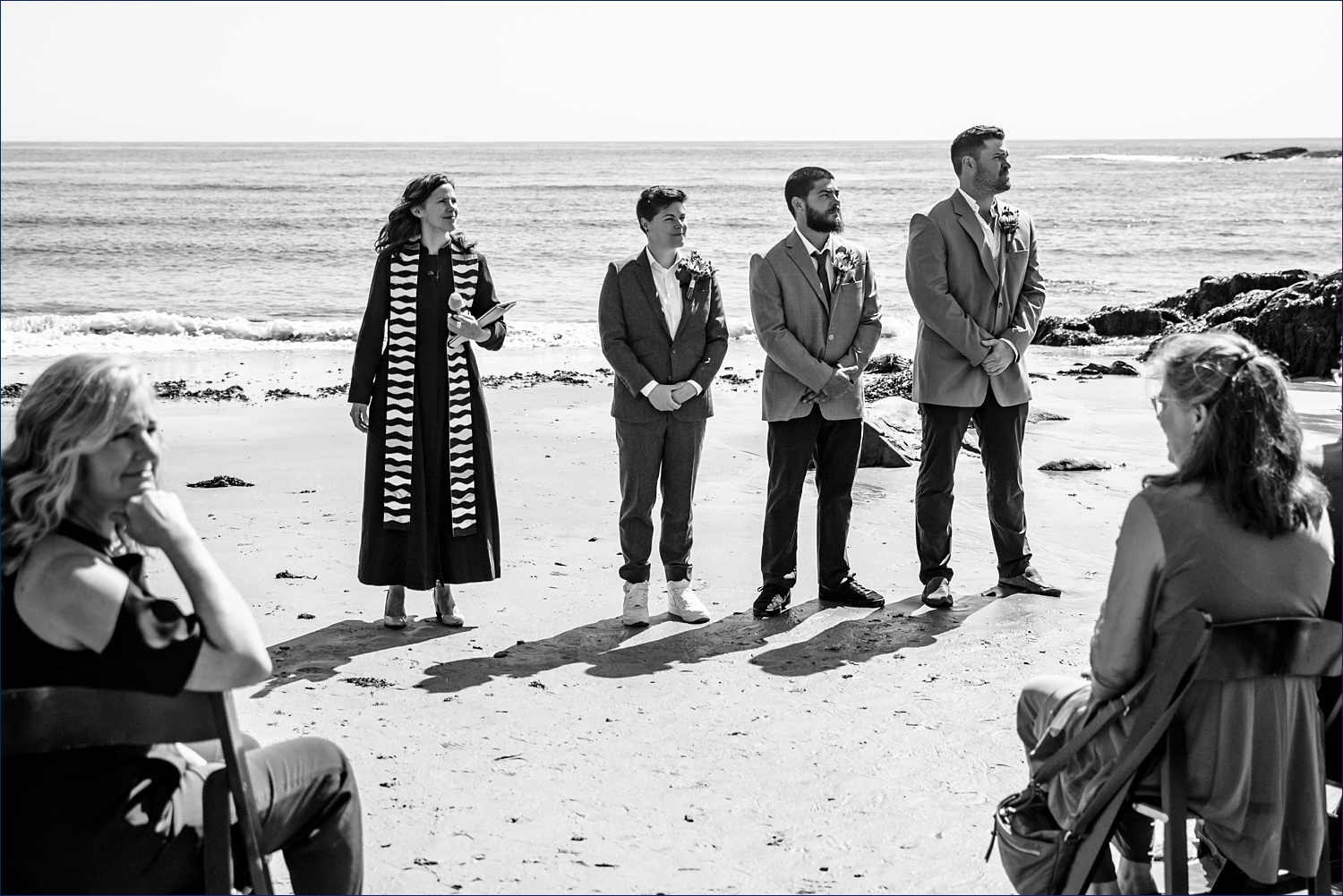 Kaylyn waits for her bride to come to the ceremony with her brothers on the beach