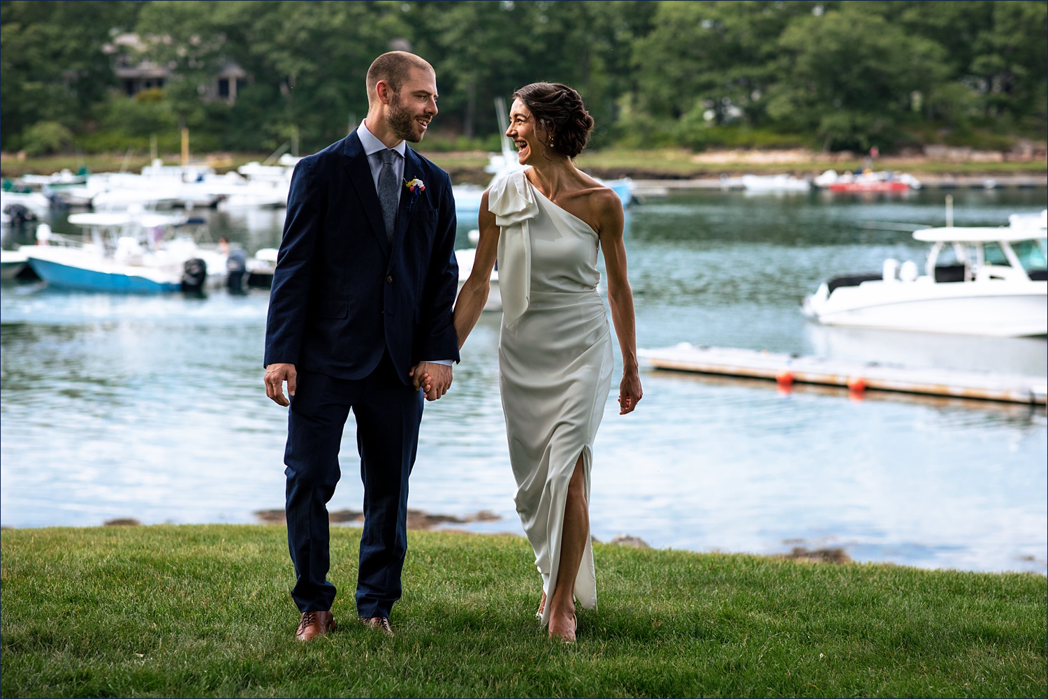 The bride and groom walk back from the dock in York Maine
