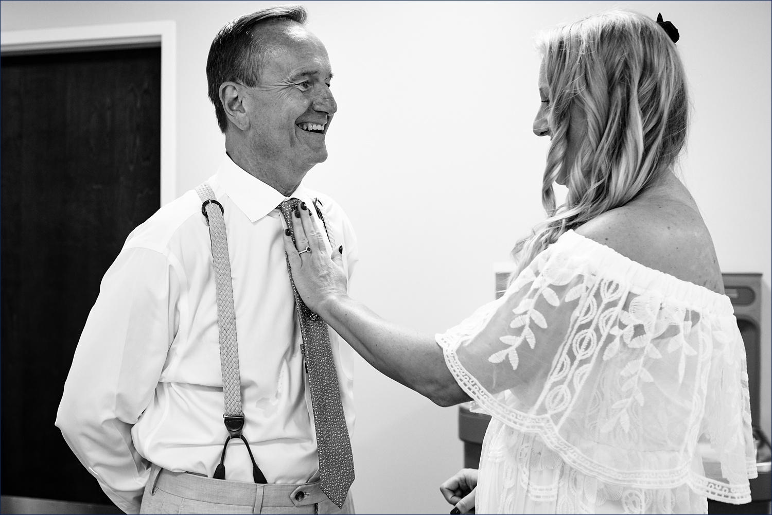The bride gets her dad's tie all set for the wedding day