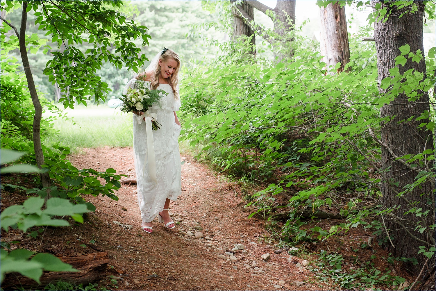 The bride walks through the woods to meet the groom for the first look