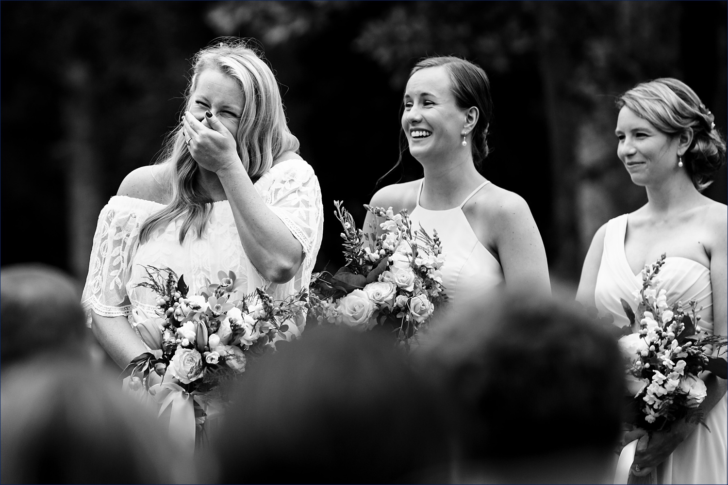 The bride can't contain her laugh on the wedding day during a funny part of the ceremony in NH