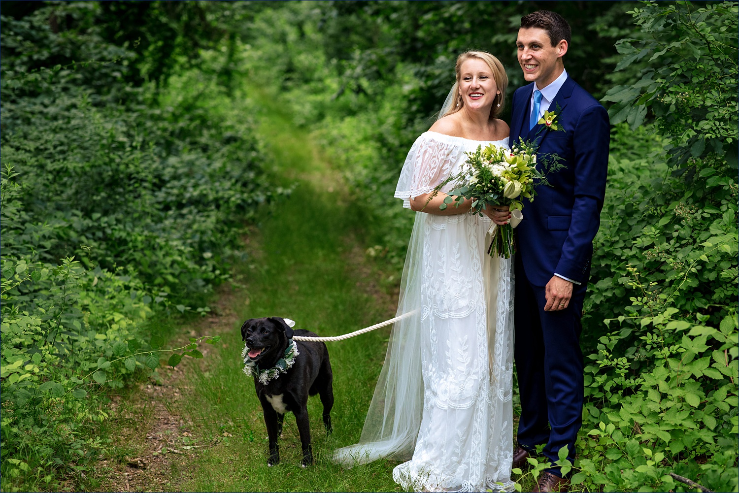 The newlyweds and their beloved dog take in some moments together on the wedding day in the woods of NH