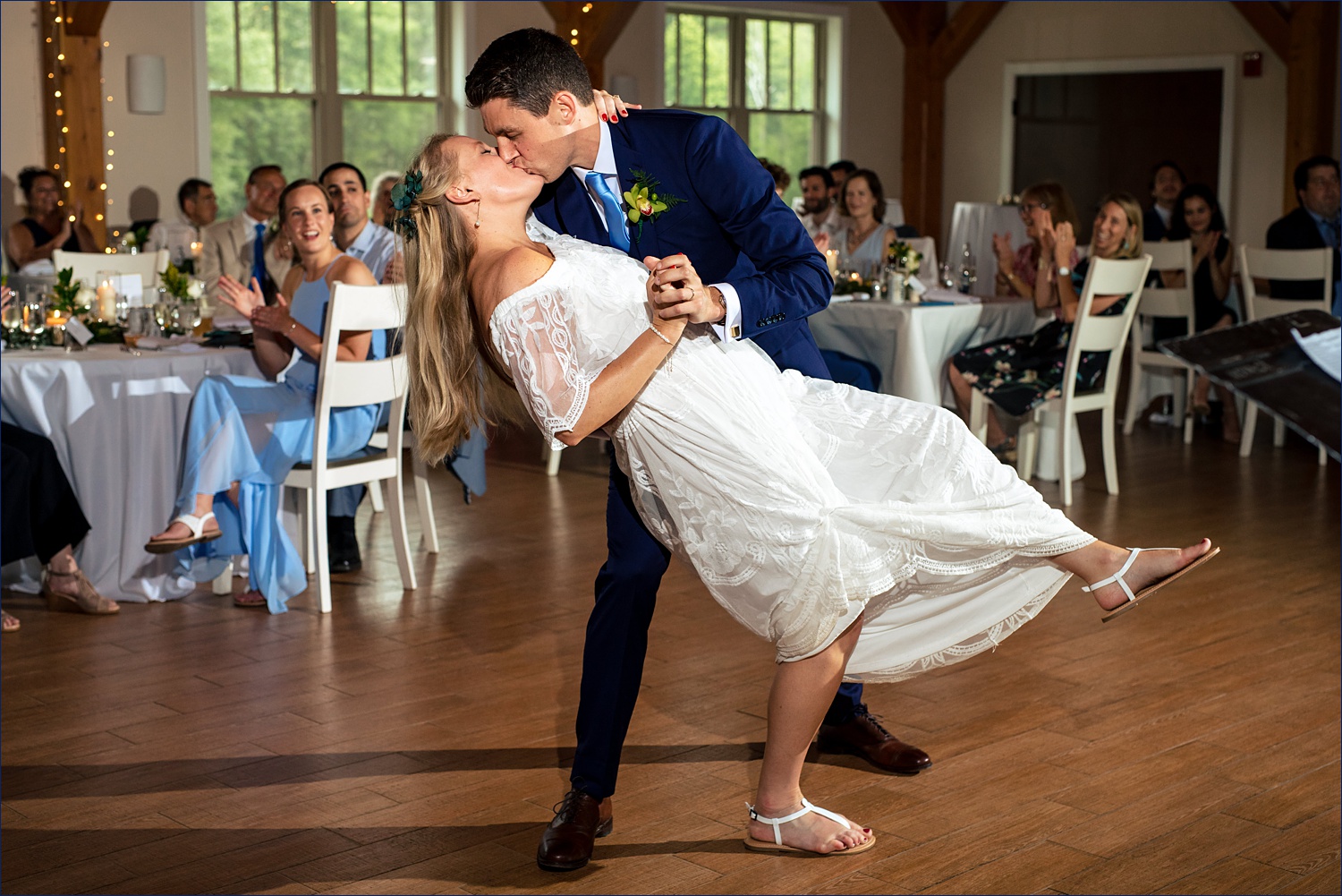 A dip and a kiss on the dance floor during the first dance of the newlyweds