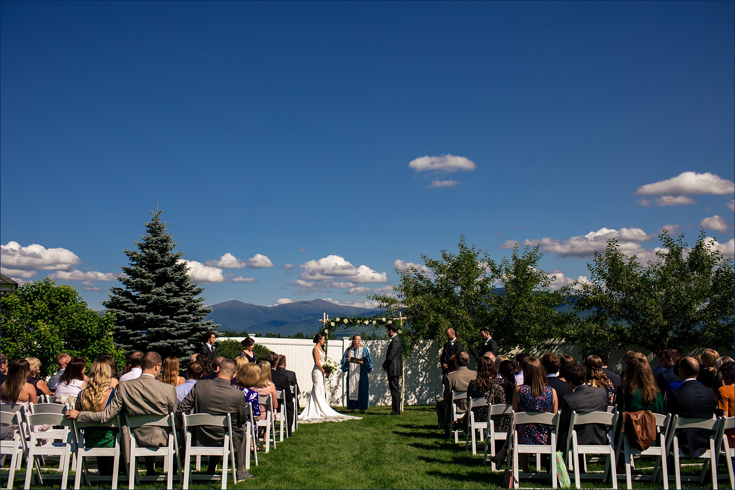 The wedding ceremony of the garden at Mountain View Grand Resort in New Hampshire overlooking the mountains
