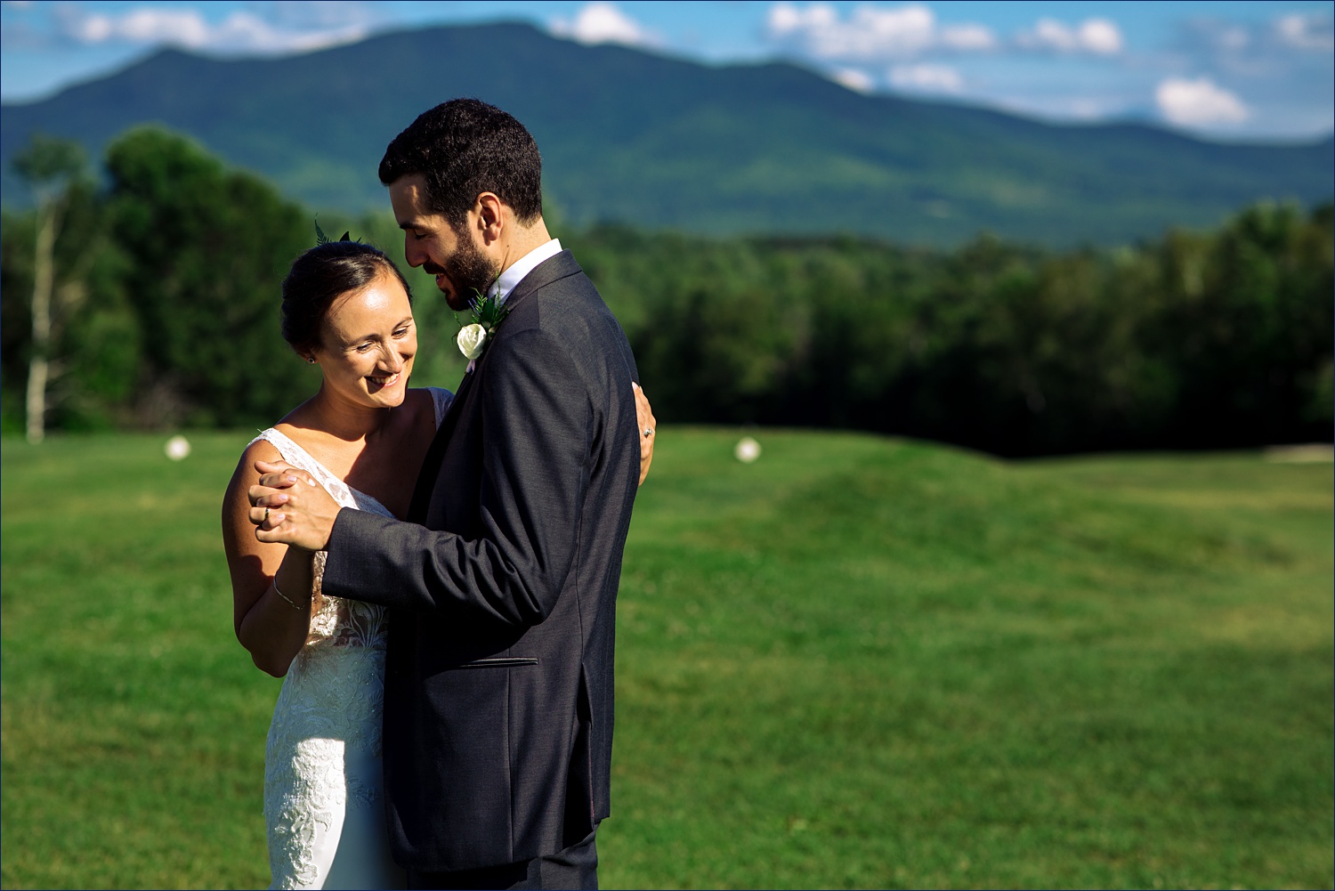 The newlyweds dance in front of the mountain range in Whitefield New Hampshire