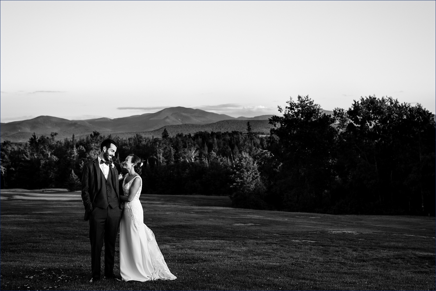 The newlyweds in front of the White Mountains in Whitefield New Hampshire
