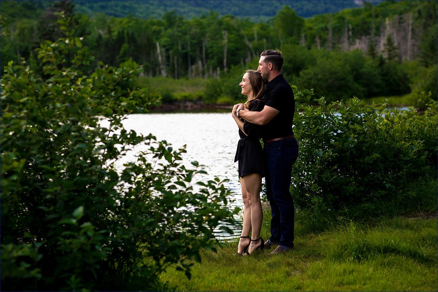 Crawford Notch lake engagement session the couple hugs one another