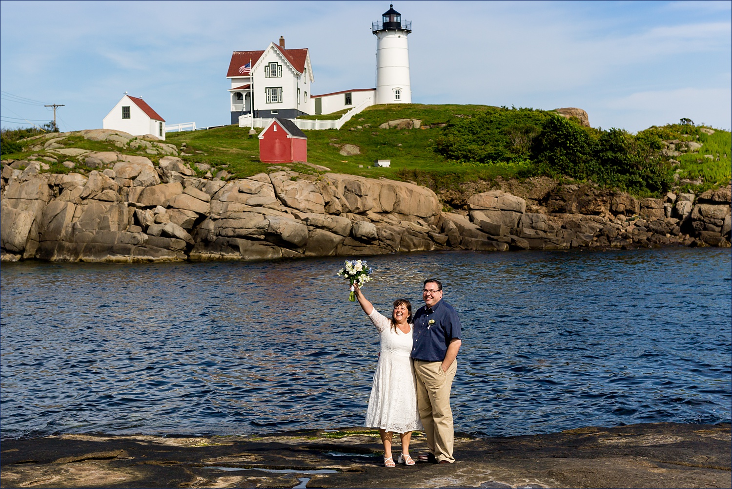 Waving to family before they elope at Nubble Lighthouse in York Maine