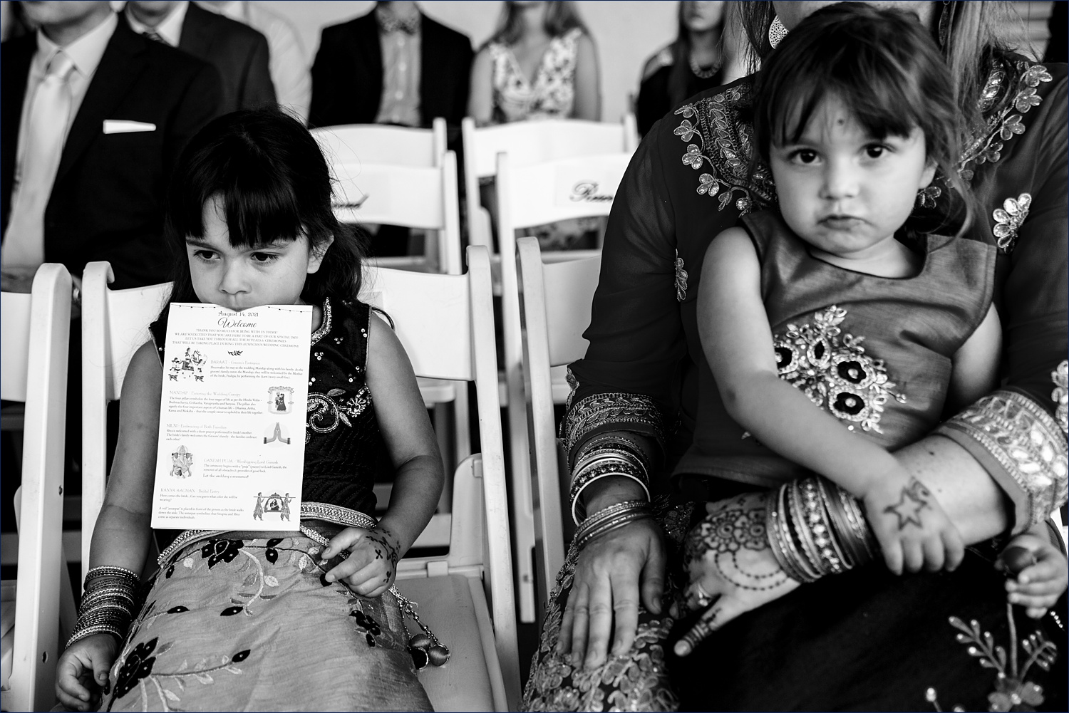 Two little ones patiently watch the wedding ceremony