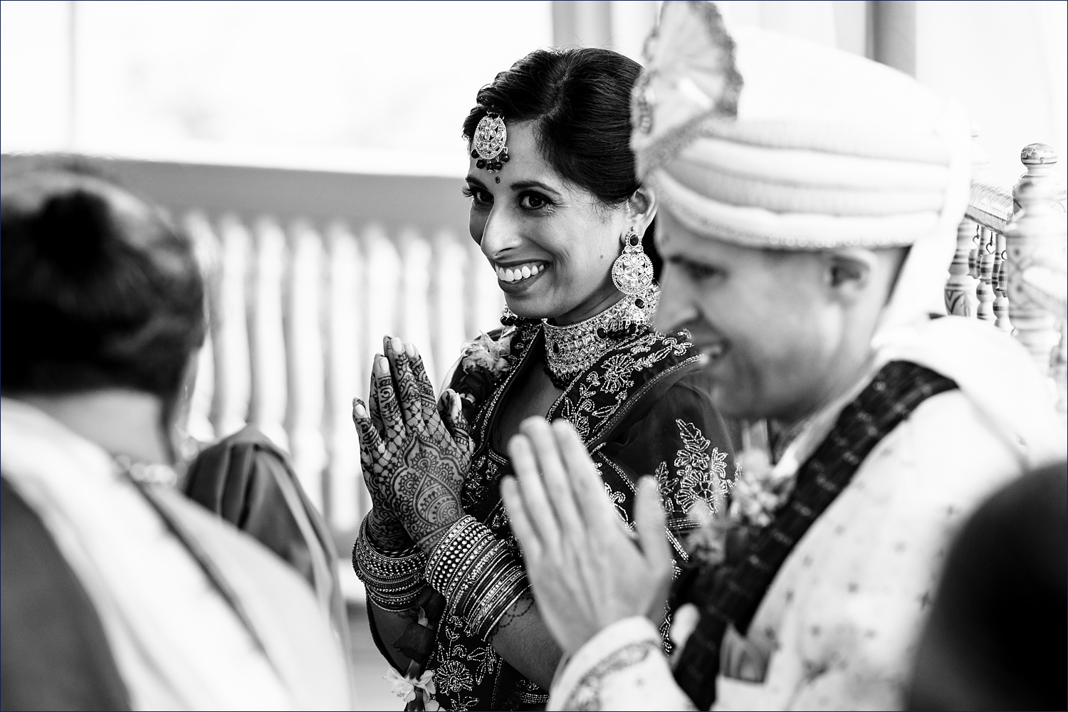 The bride smiles at the Hindu priest during the wedding ceremony