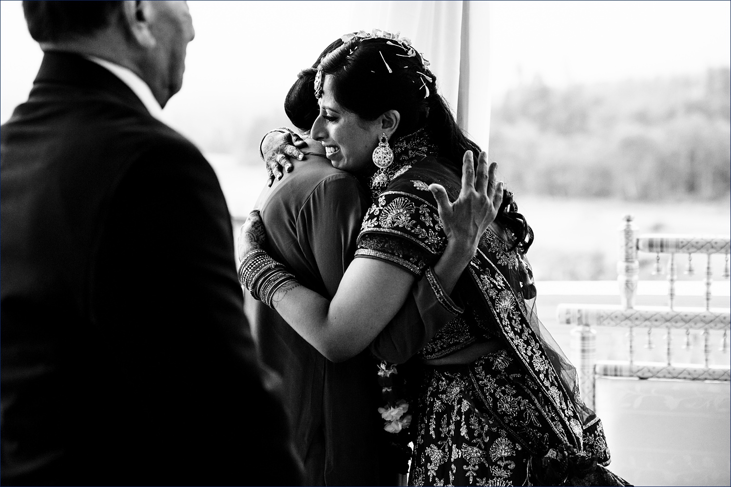 A tearful bride and her mom hug each other on the bride's wedding day