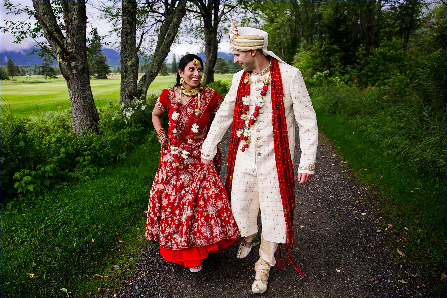 The newlyweds walk through the property of Omni Mount Washington Resort sharing a laugh