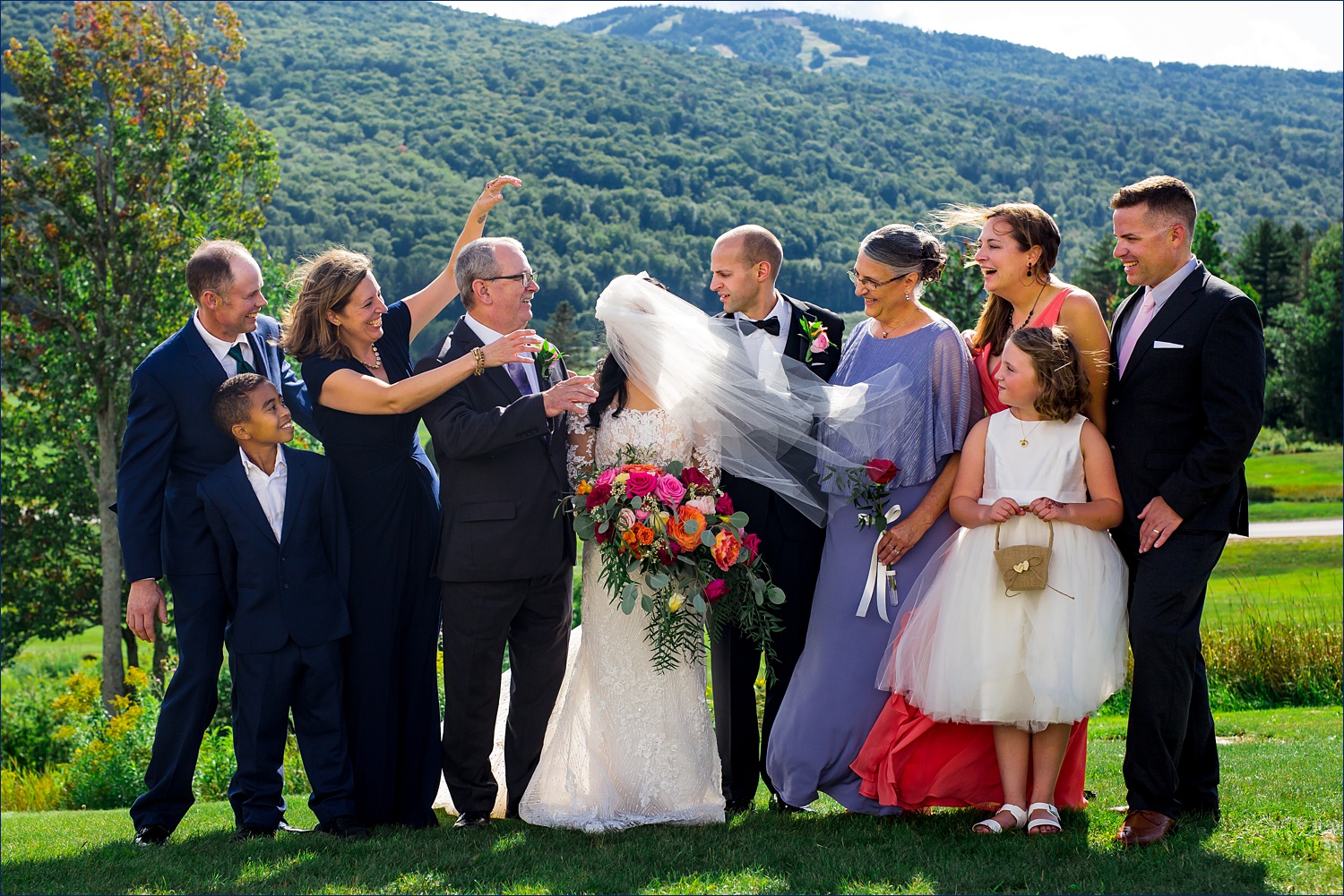 The bride's veil goes wild during the formal family photos in NH