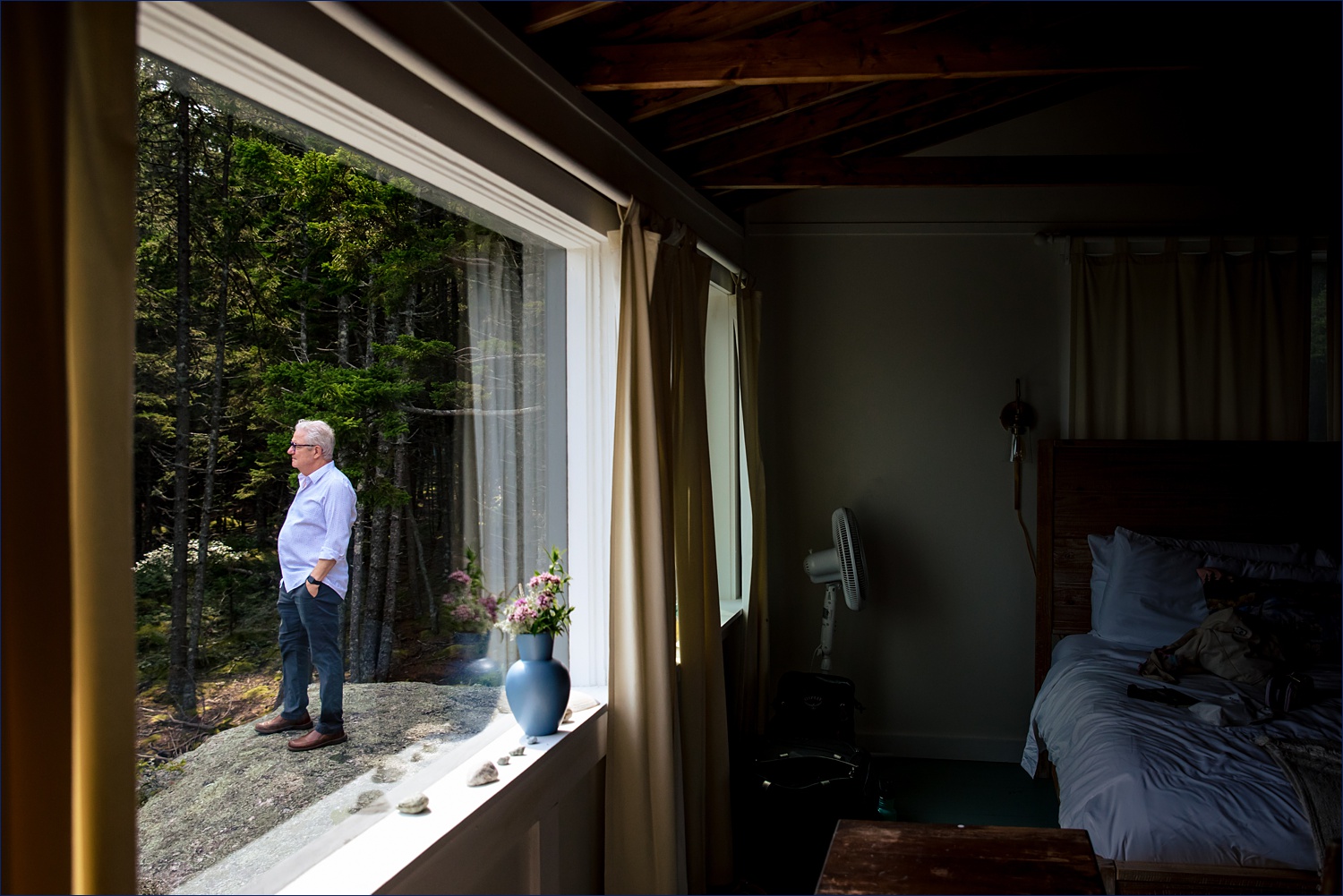 The bride's father waits outside for his daughter on her Maine wedding day
