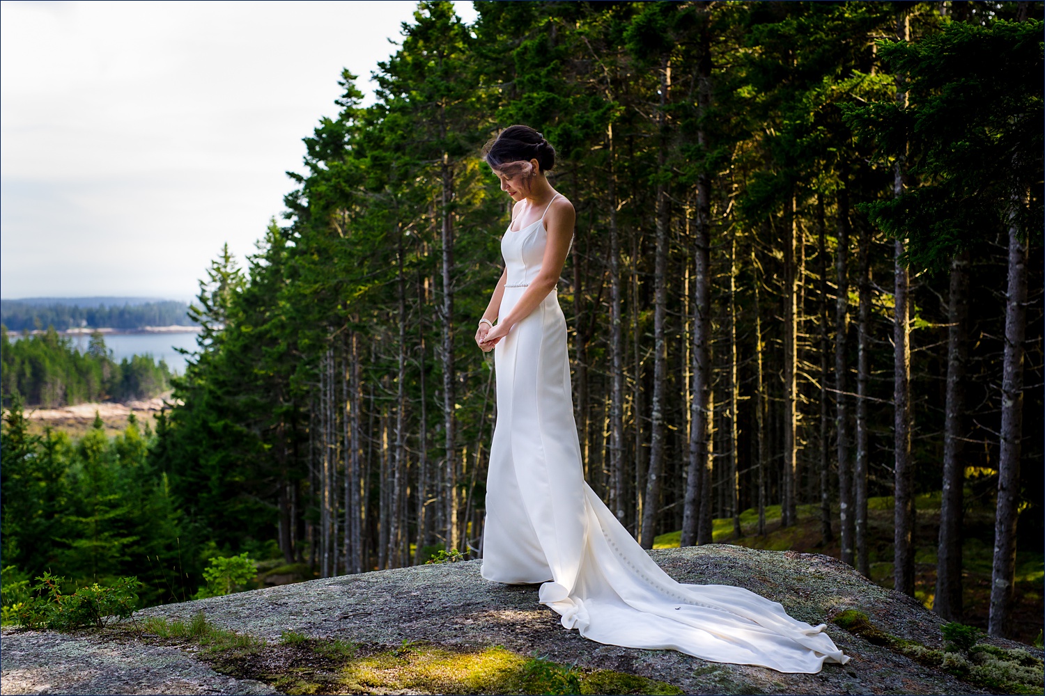 The bride stands outside of Aragosta on Deer Isle Maine on her wedding day