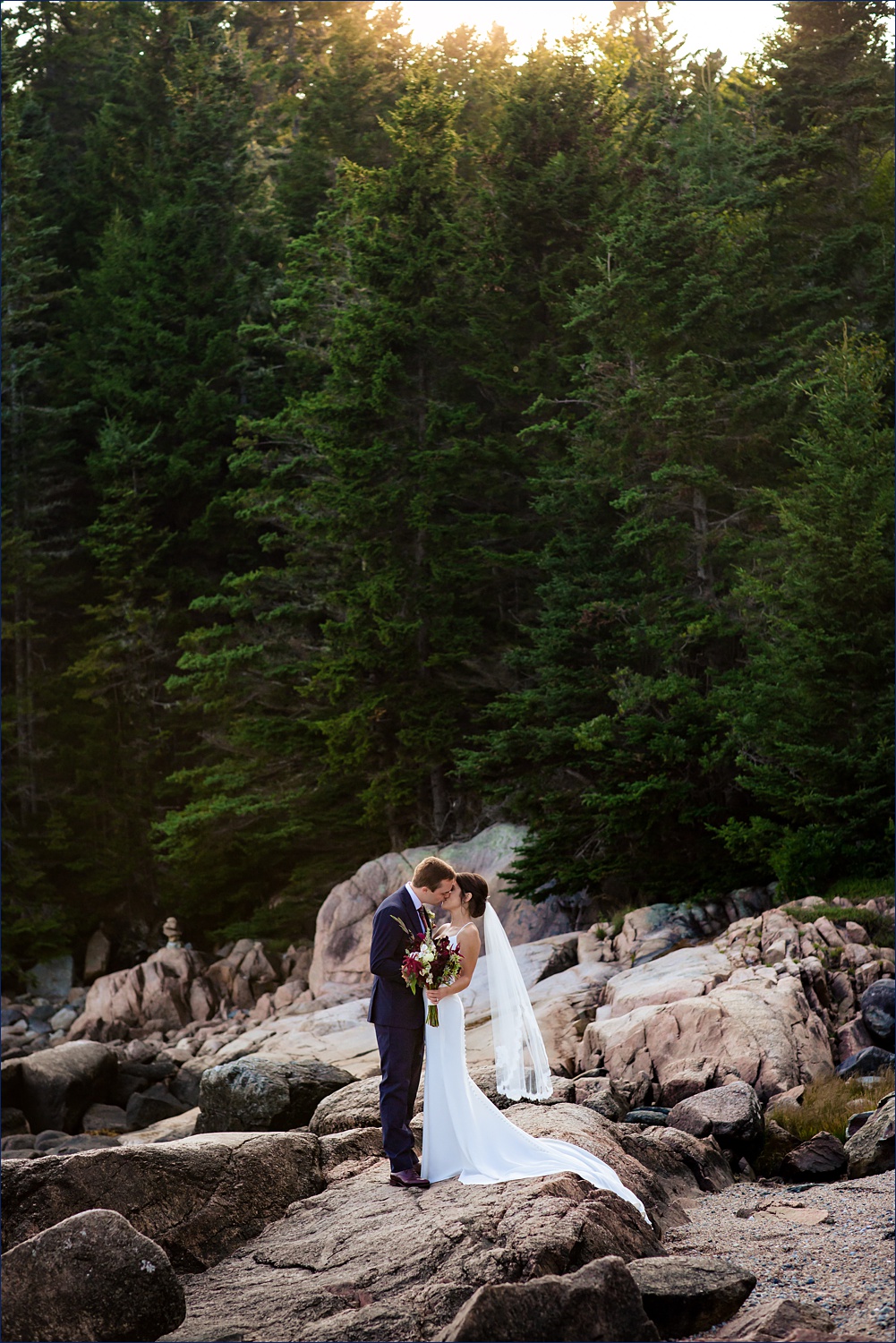 The newlyweds in front of the majestic coastal Maine woods