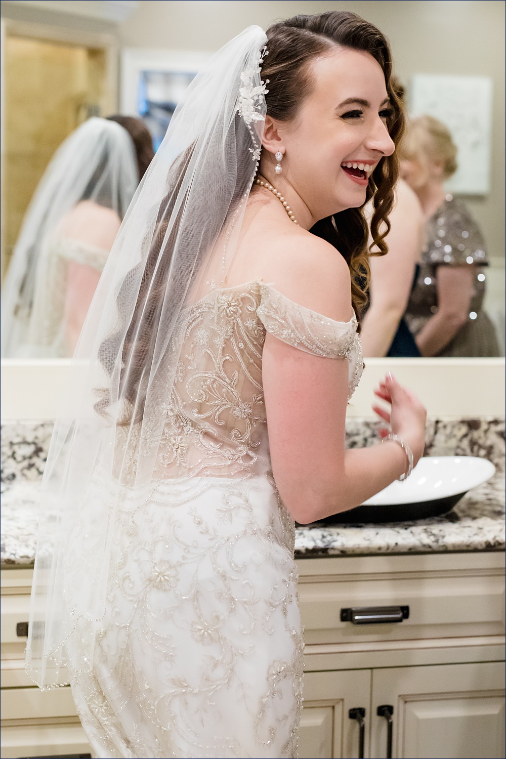The bride laughs after getting into her modern wedding day dress