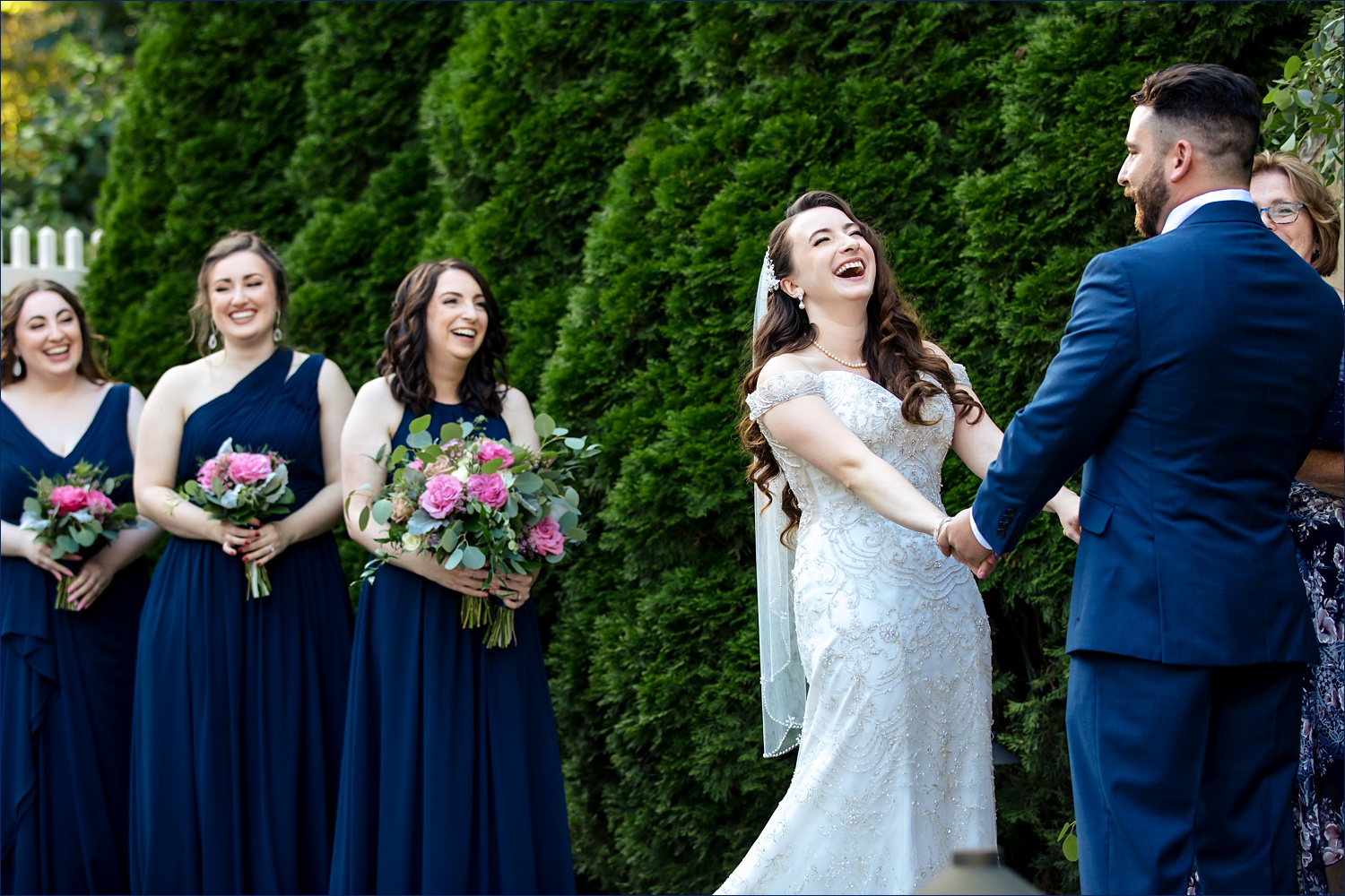 The bride laughs during her backyard New Hampshire wedding day